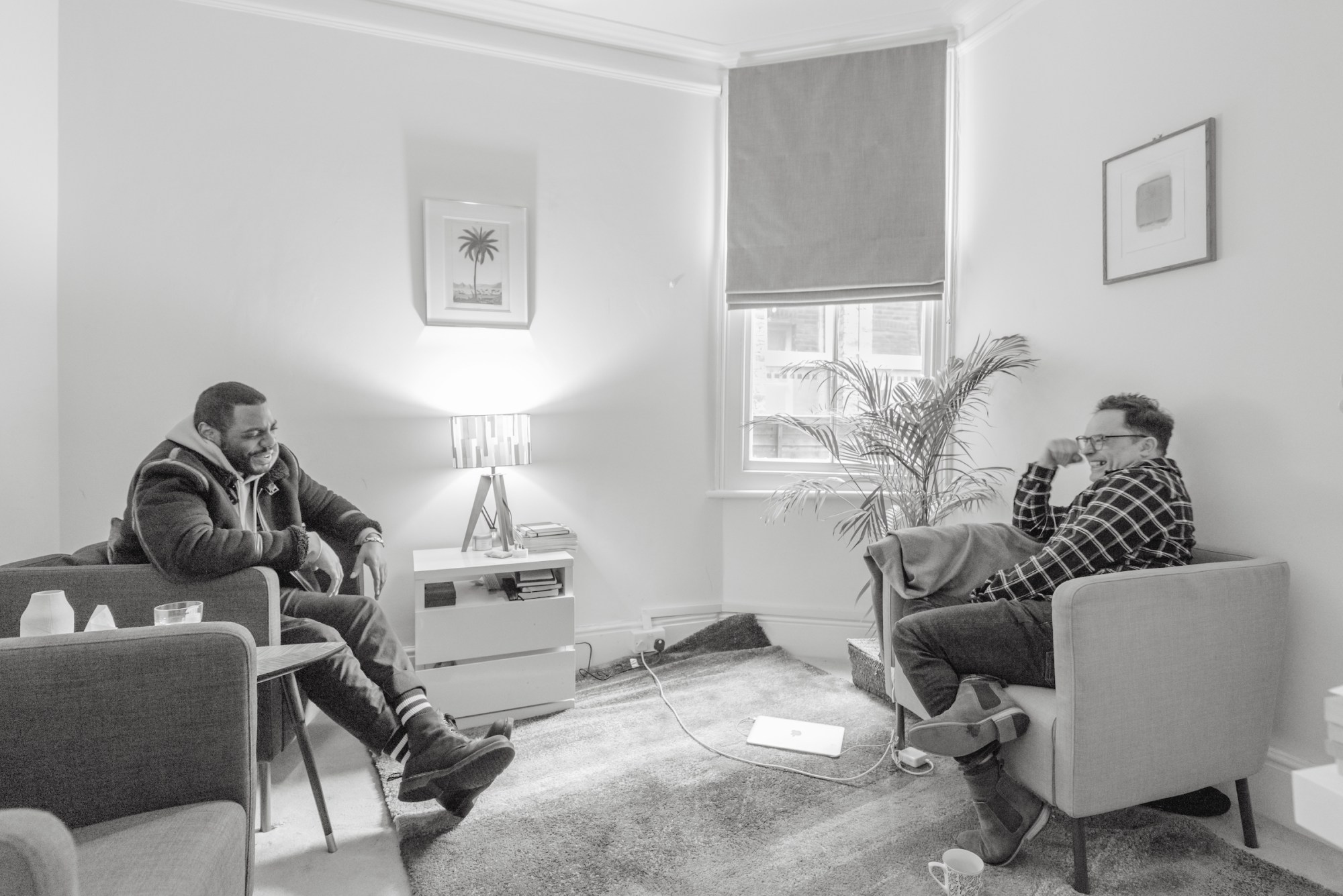 photograph of two men talking in a living room from the Notes on a Native Son: After Baldwin exhibition at Peckham 24 2023