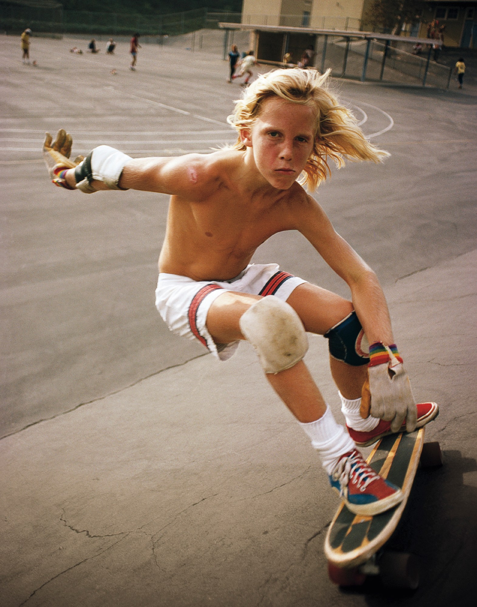 young skater with blonde hair riding his board in california by hugh holland