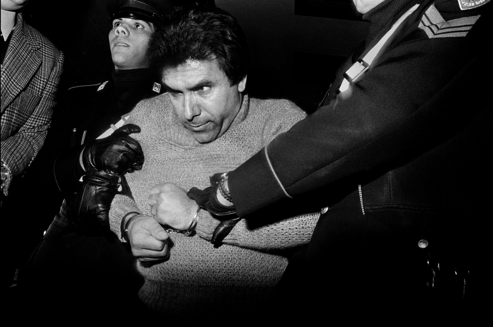 black-and-white photograph by Letizia Battaglia of a man being arrested