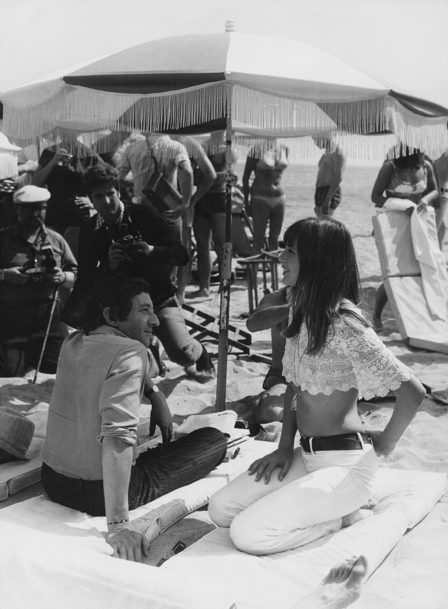 Serge Gainsbourg and Jane Birkin sitting on the beach at Cannes Film Festival 1969