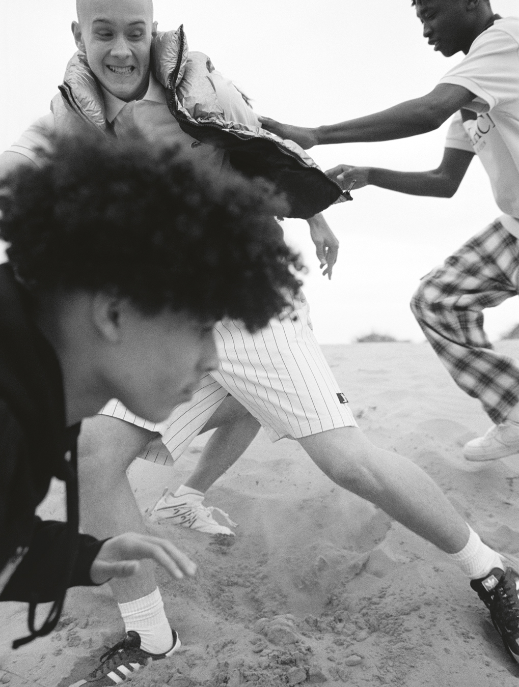 Students Denys Lysenko, Balla Shom, Jesu Guerra, Billy Cole photographed by Oliver Hadlee Pearch on Camber Sands.