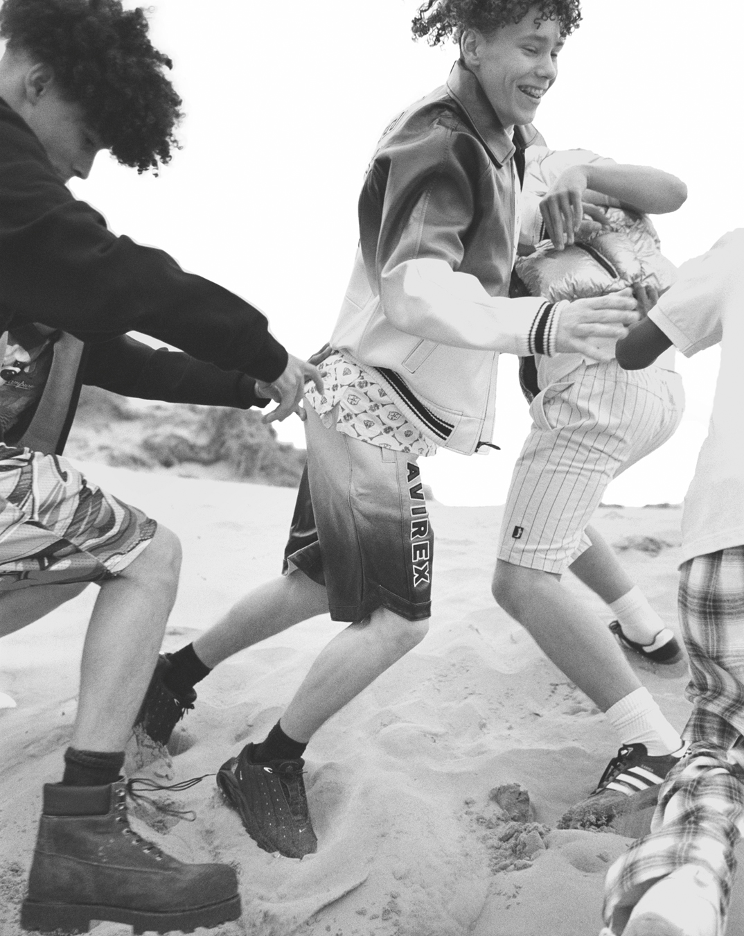 Students Denys Lysenko, Balla Shom, Jesu Guerra, Billy Cole photographed by Oliver Hadlee Pearch on Camber Sands.