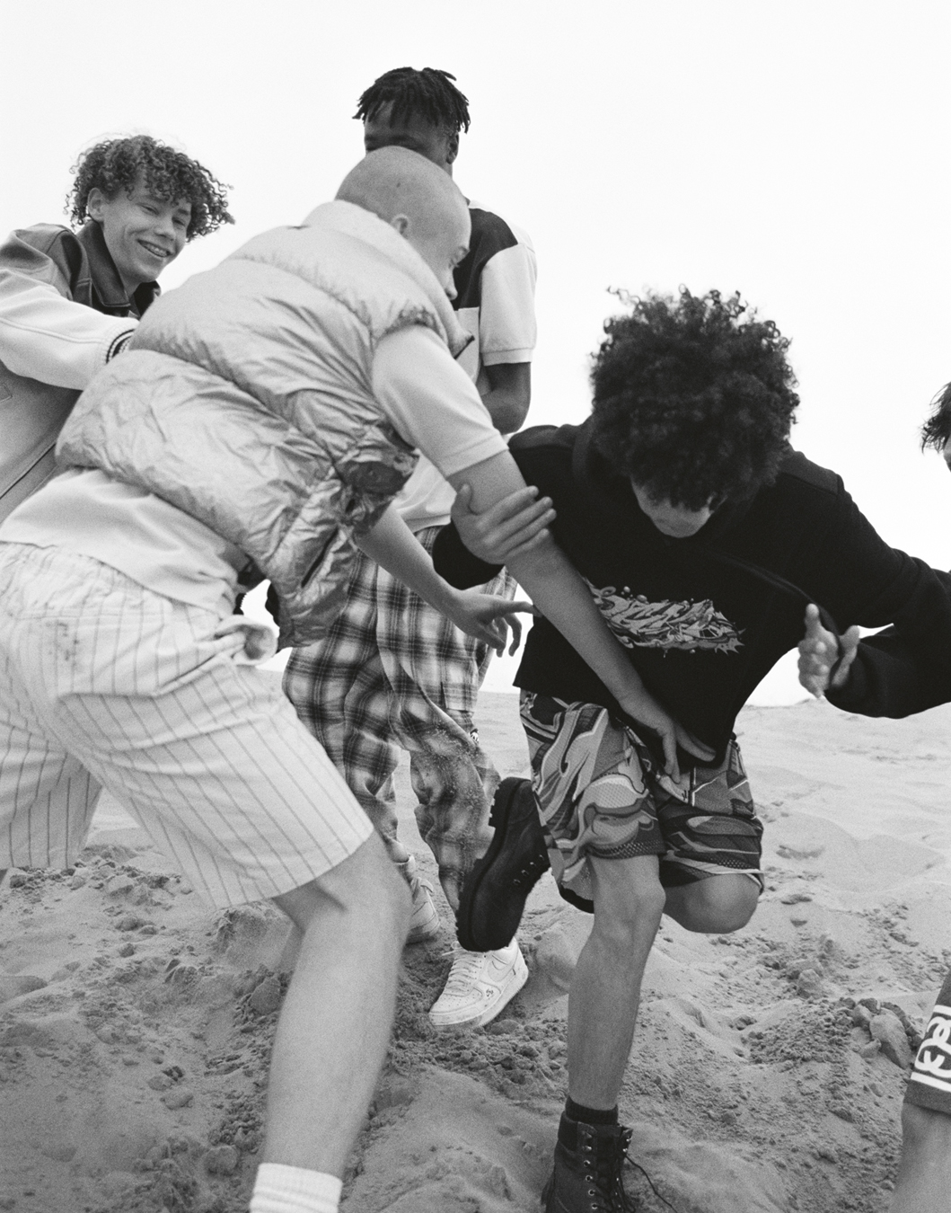 Students Denys Lysenko, Balla Shom, Jesu Guerra, Billy Cole photographed by Oliver Hadlee Pearch on Camber Sands.