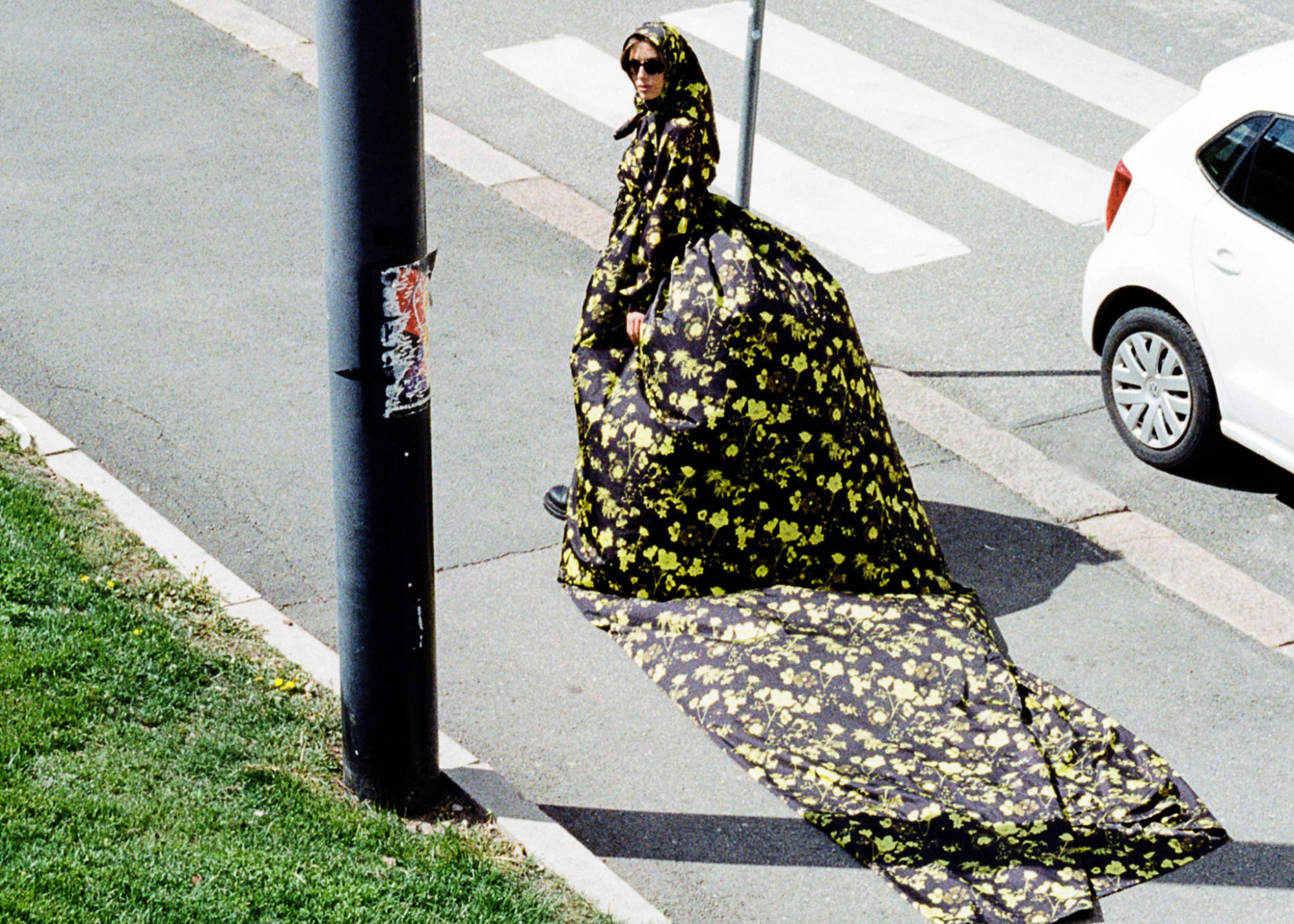 a model in a bulbous printed dress by rolf ekroth walking down the street in copenhagen