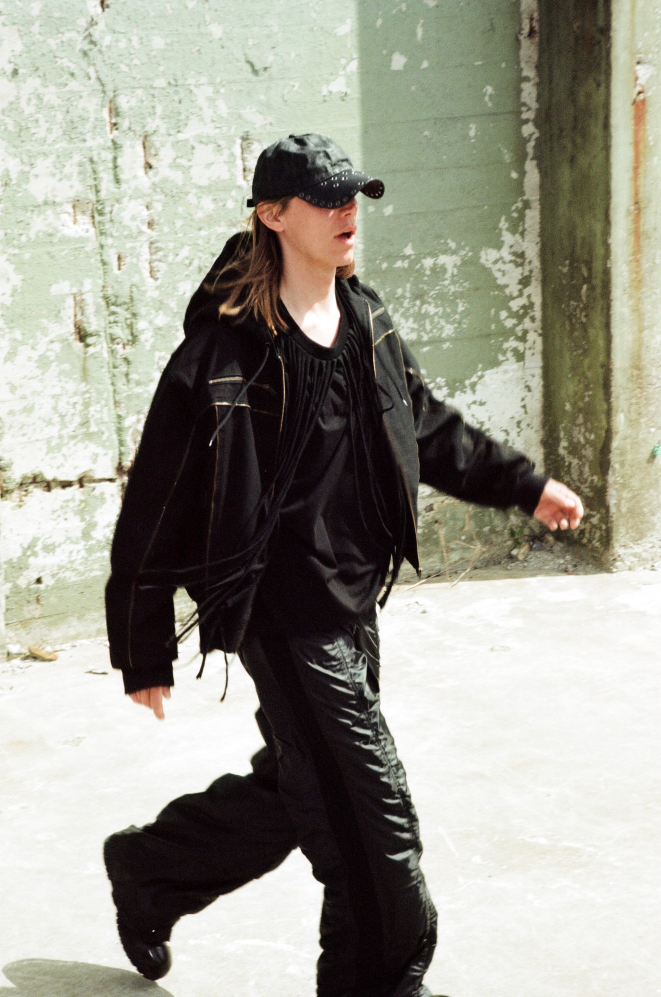 a model walking in p.l.n. sport hoodie, fringe t-shirt and grommet hat