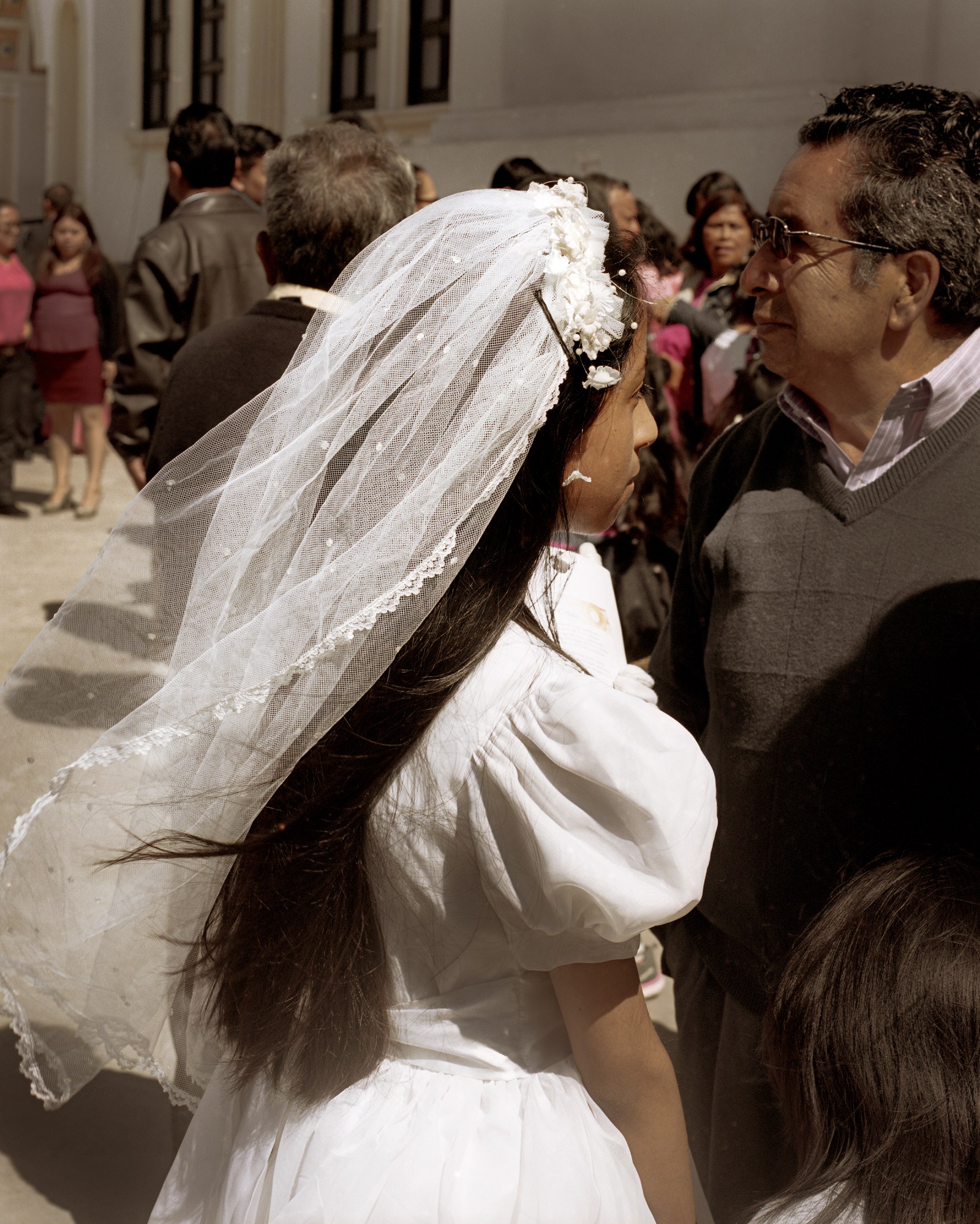 guatemalan teen getting married with her veil blowing in the wind