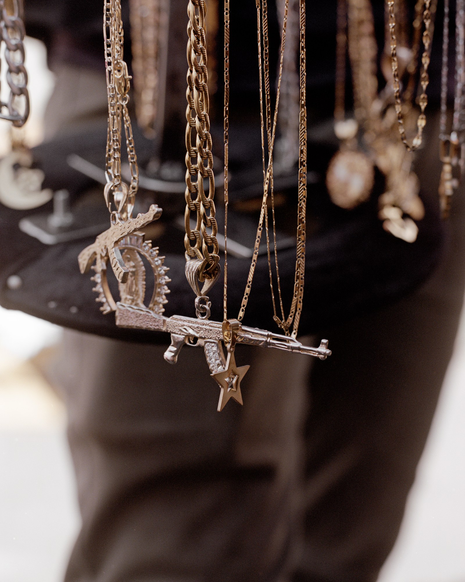 gold and silver chains and gun pendants