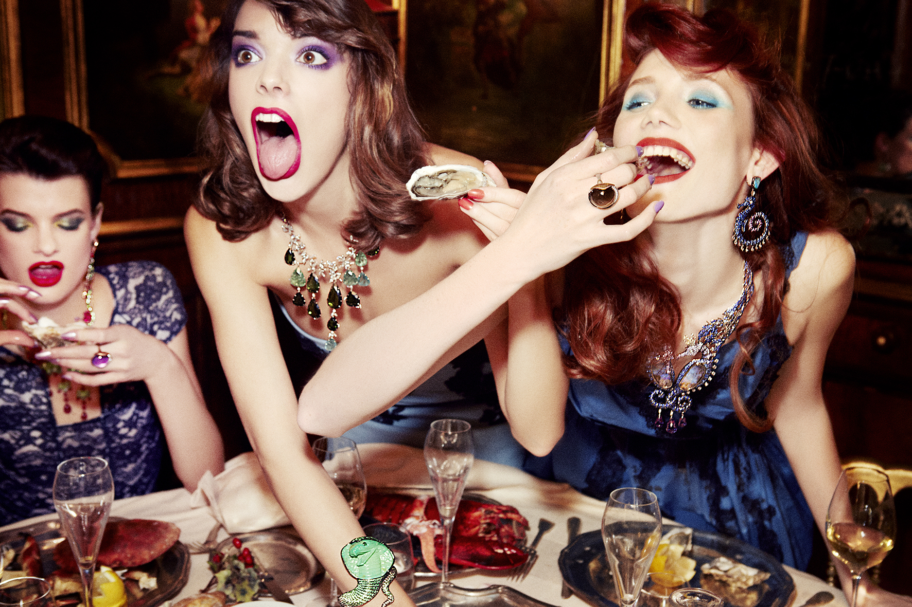 a group of models eatings oysters by ellen von unwerth