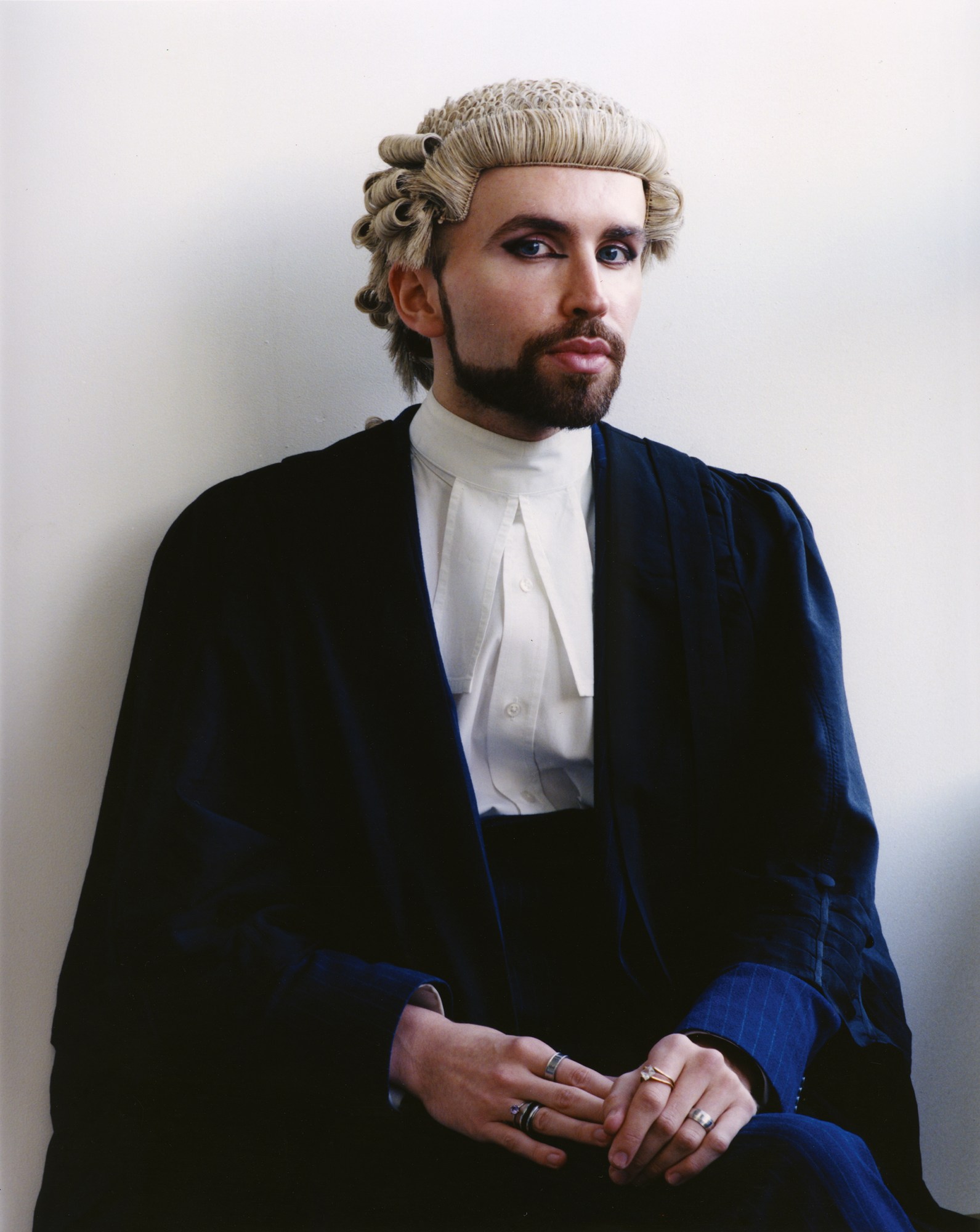 a portrait of a judge wearing eye make-up