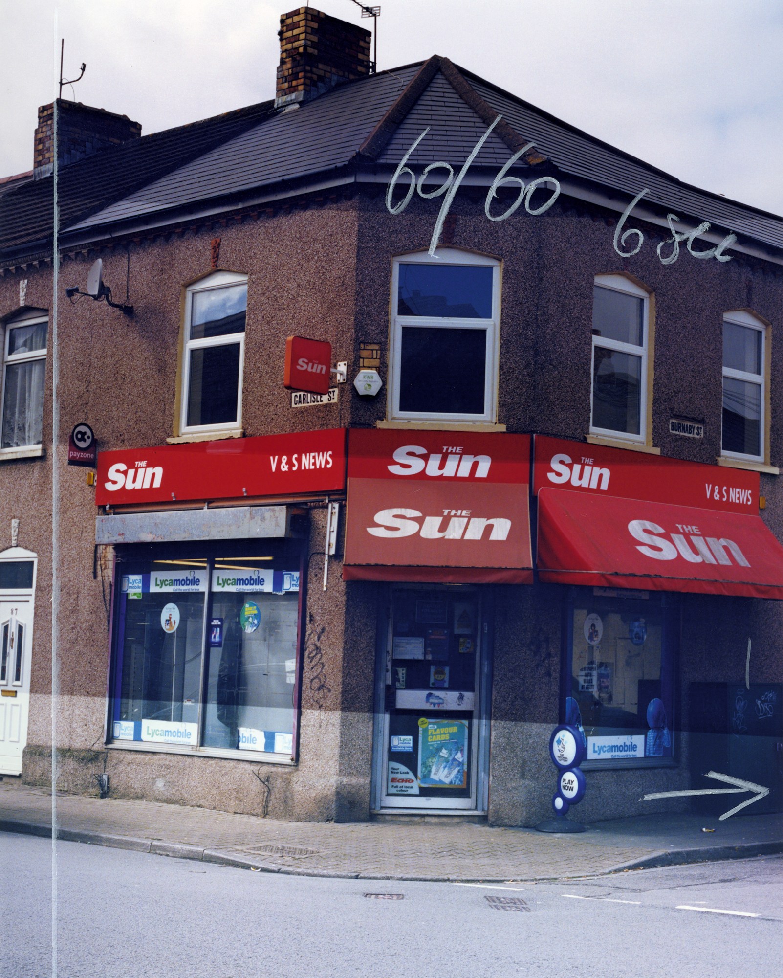 an annotated photograph of a corner shop with The Sun awnings over the windows