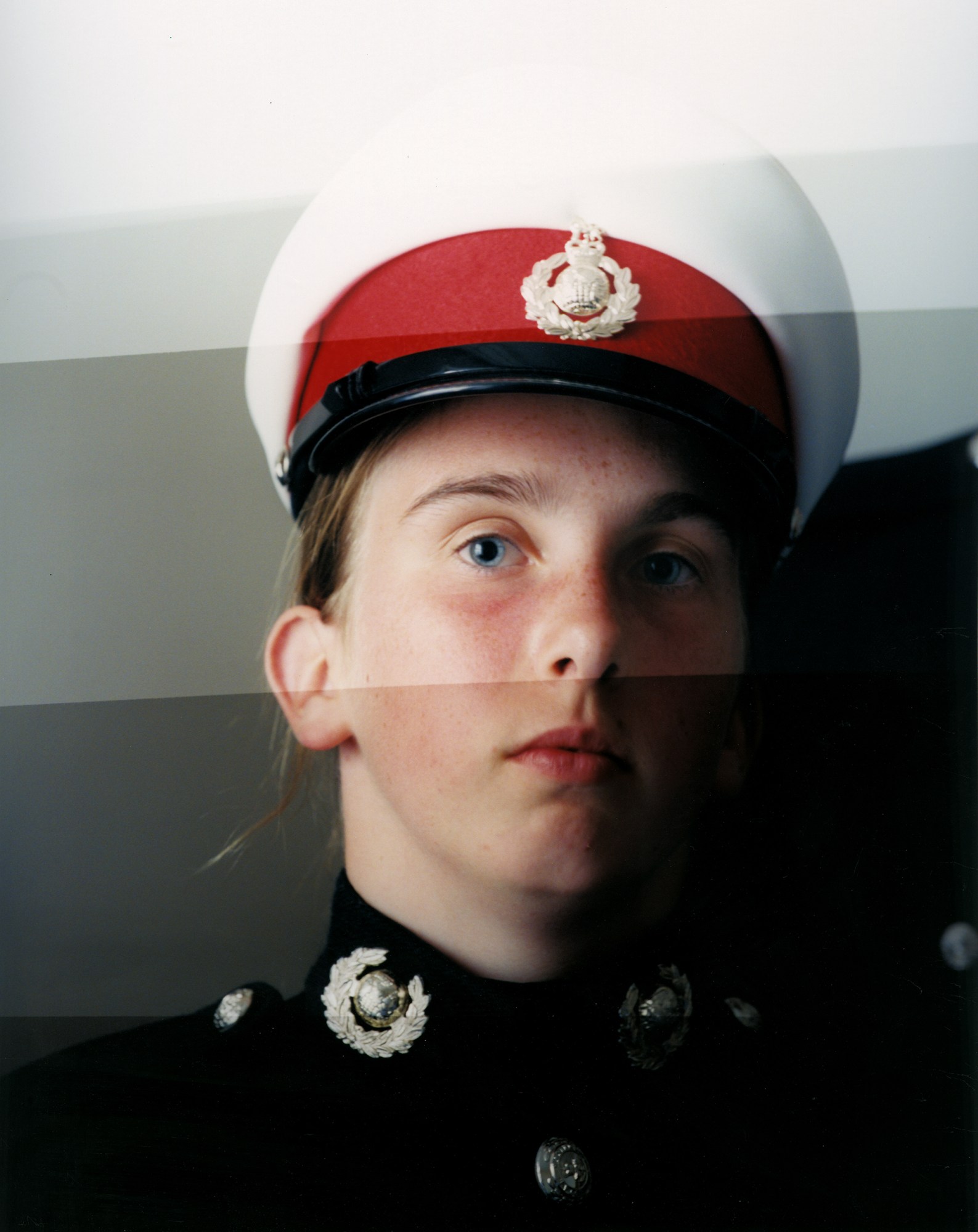 a portrait of a person with blue eyes and blond hear wearing military uniform