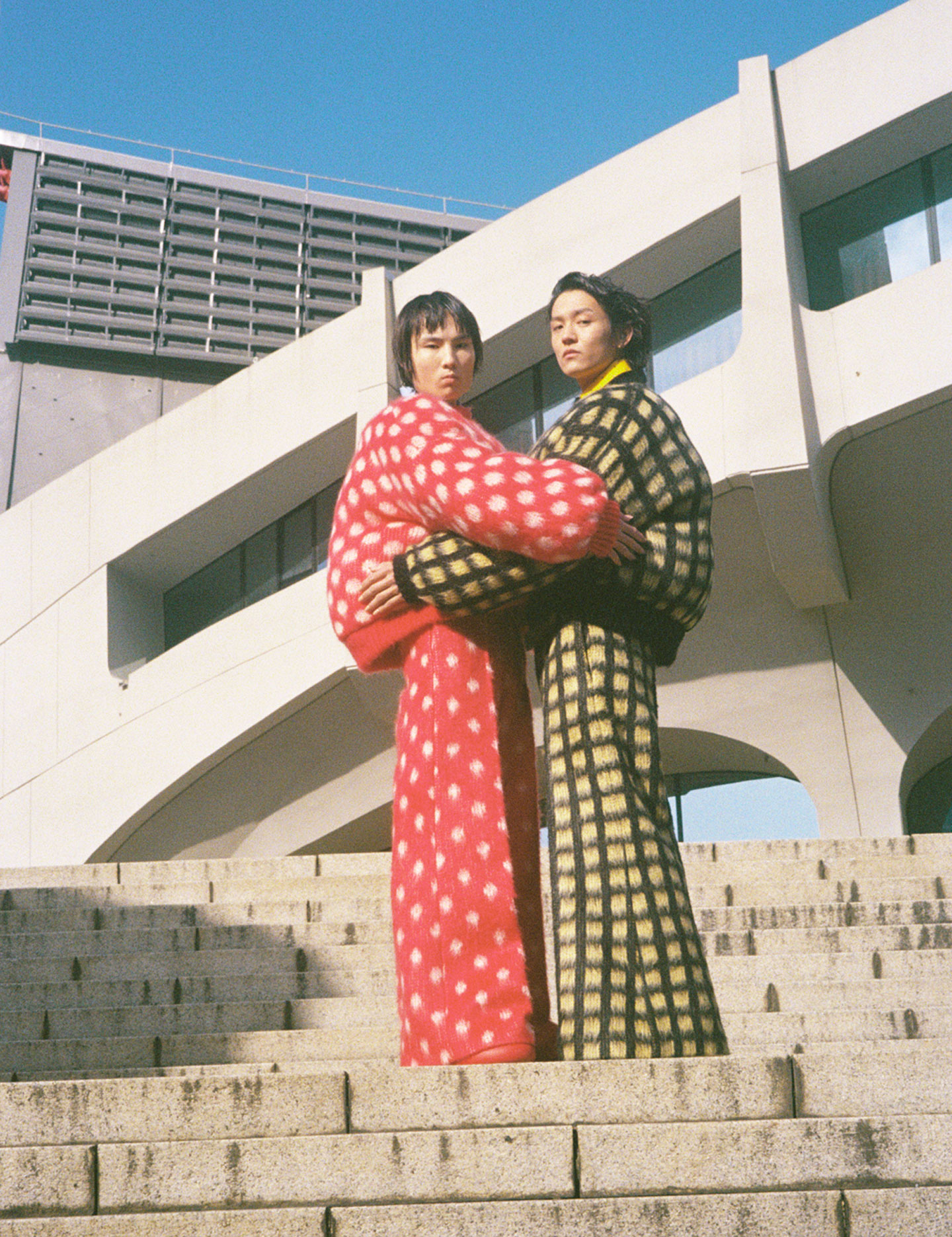 two models stand embracing on concrete steps wearing fluffy marni aw23 looks