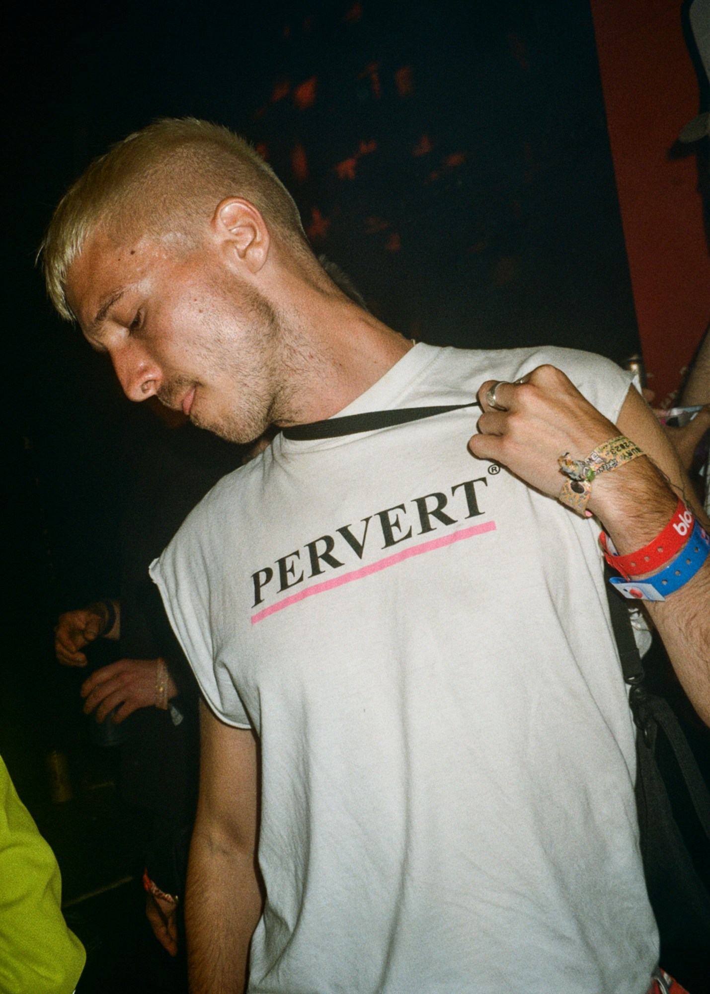 a man wearing a white shirt featuring the word pervert