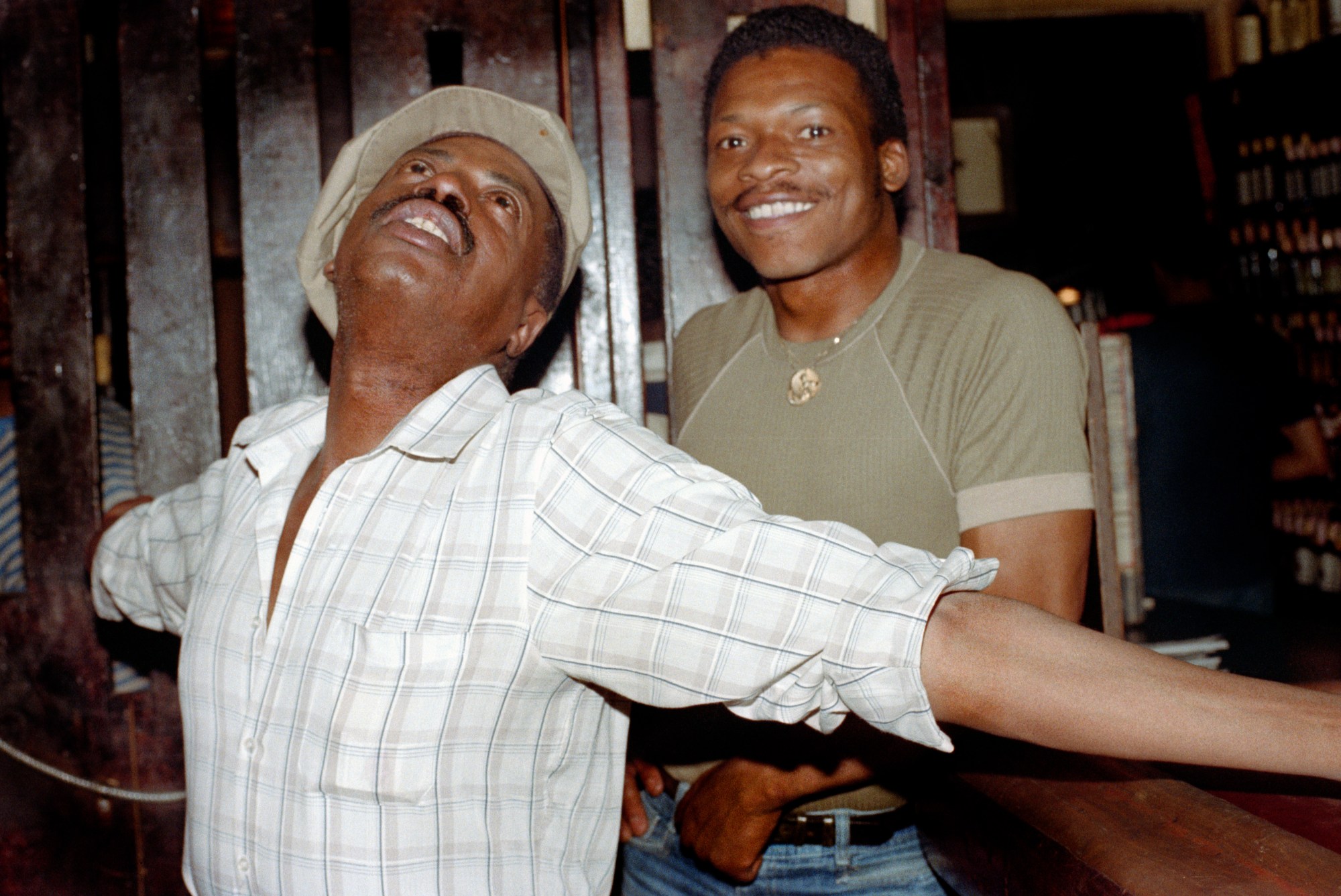 two men posing for a photo in a bar