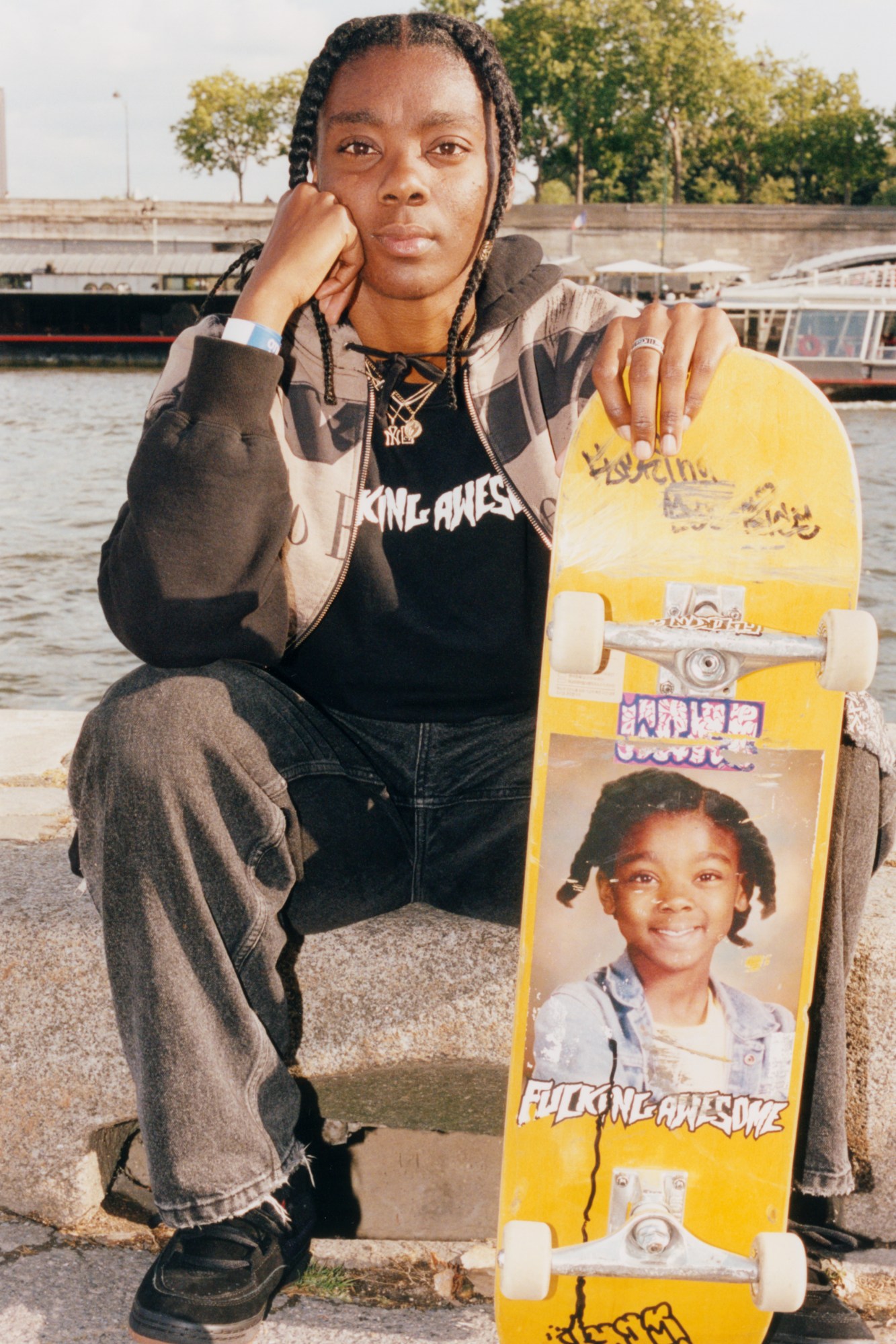 beatrice domond holding her skateboard alongside the seine