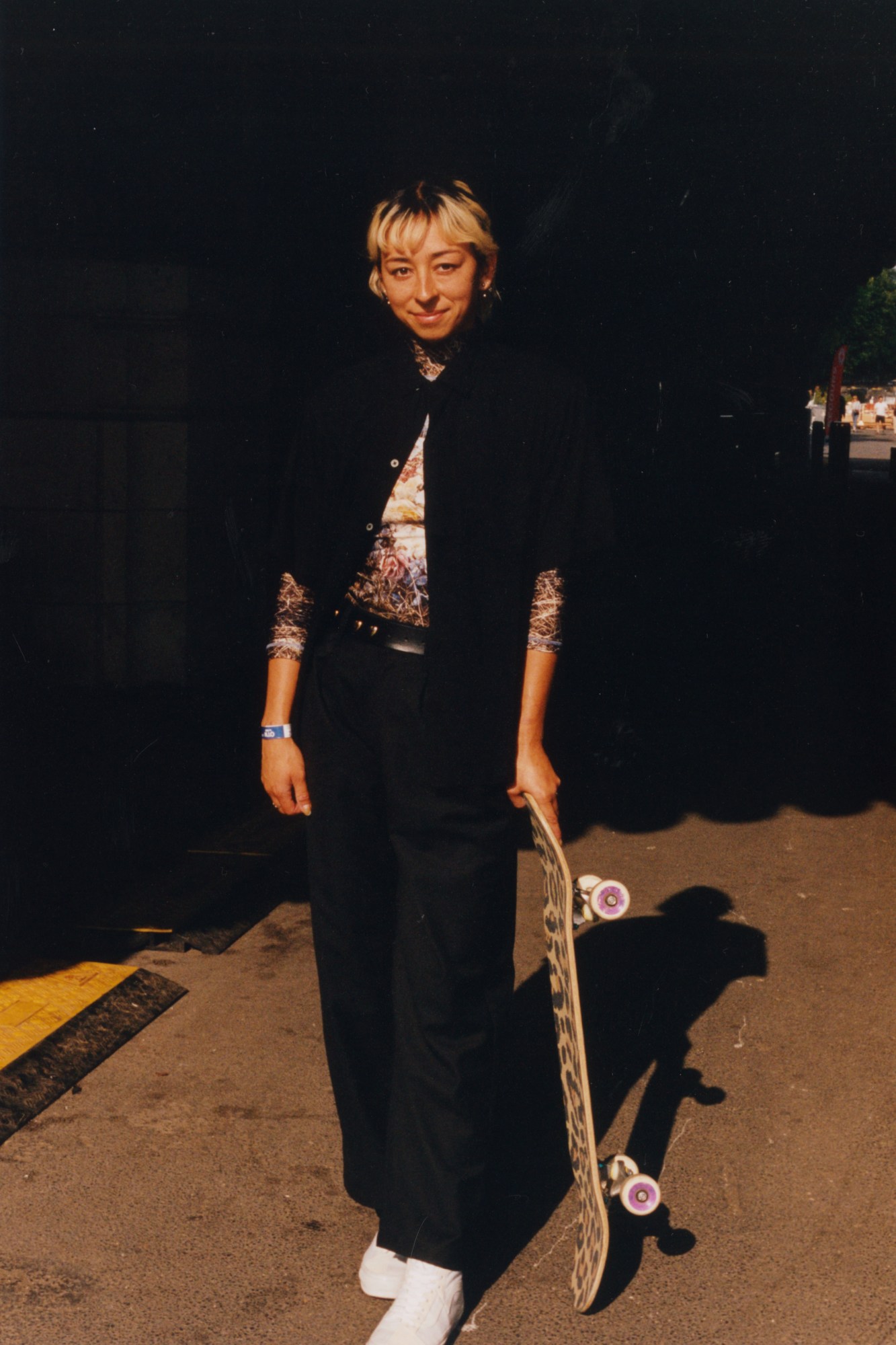 lizzie armanto posing with her cheetah skateboard under pont alexandre III