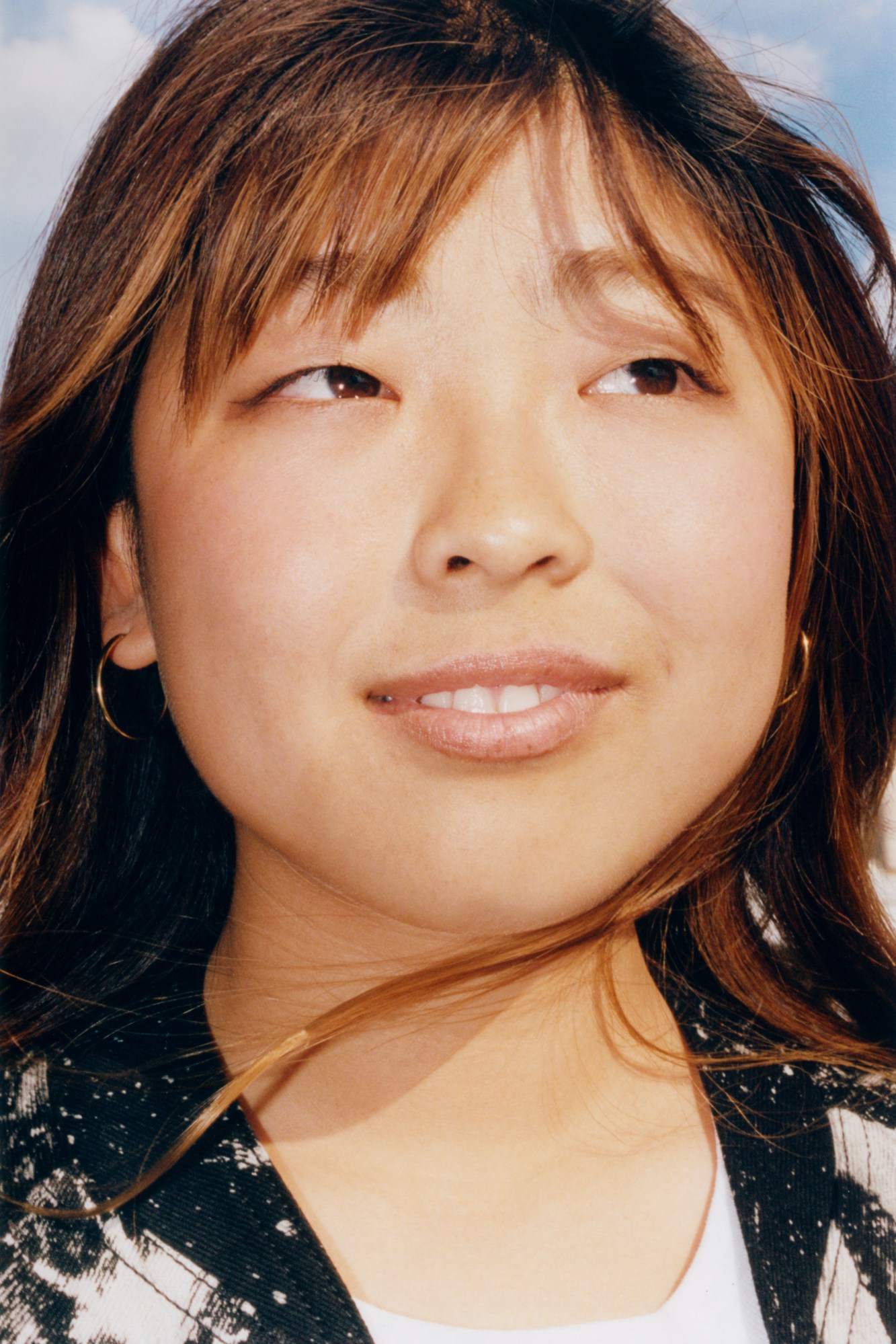 close up portrait of mami tezuka with her hair blowing in the wind