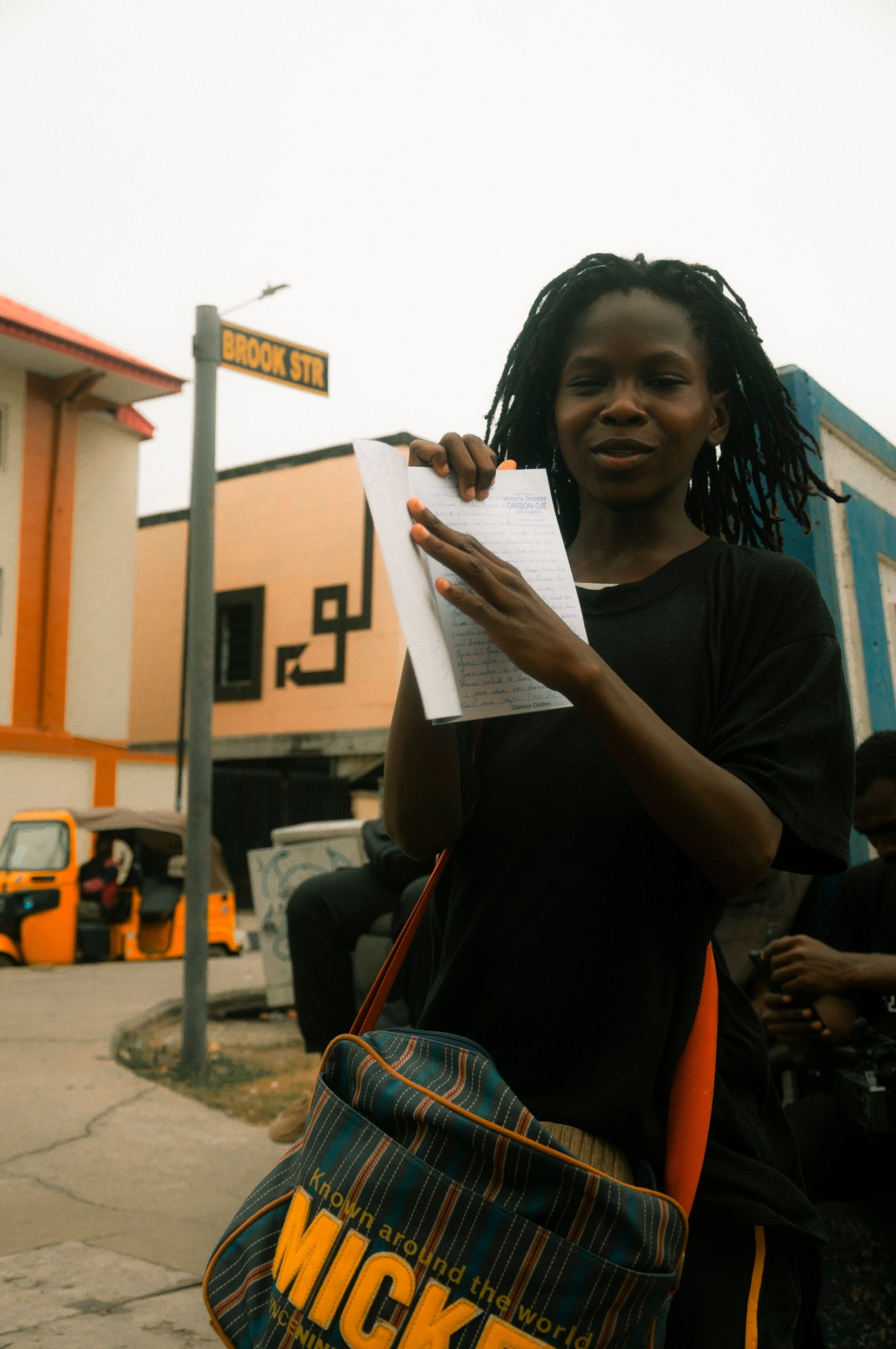 a teenager holds up a school book