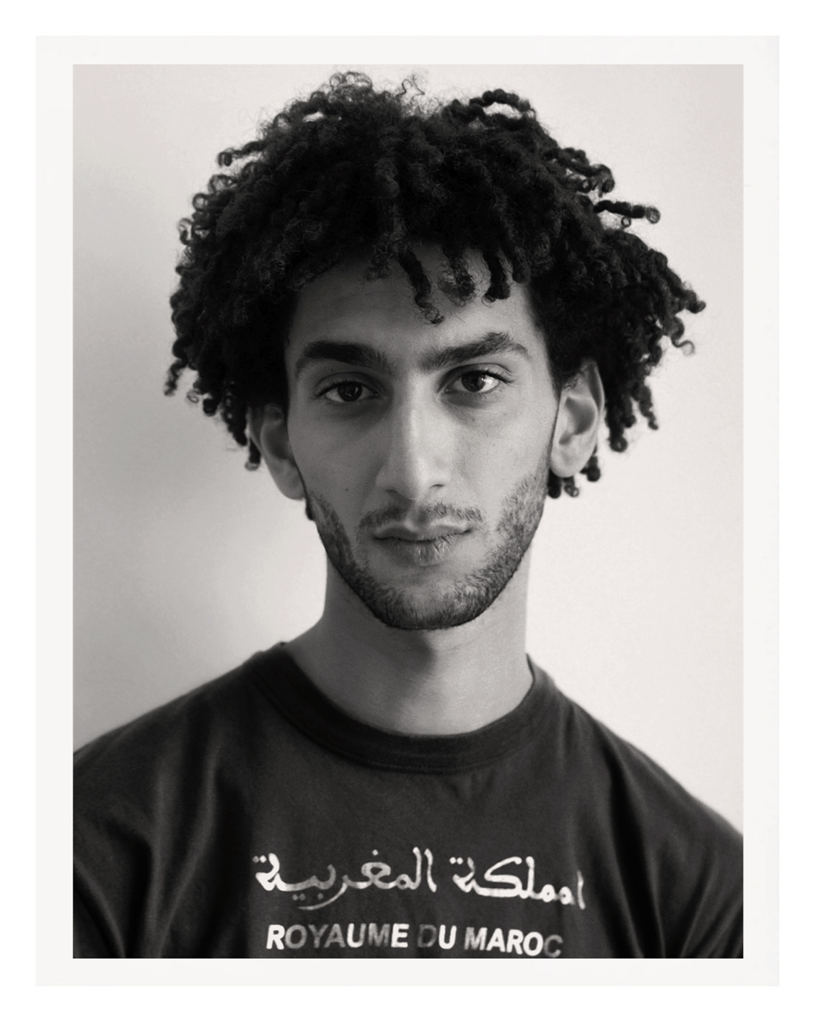 black-and-white photo of a parisian young man in a black t-shirt