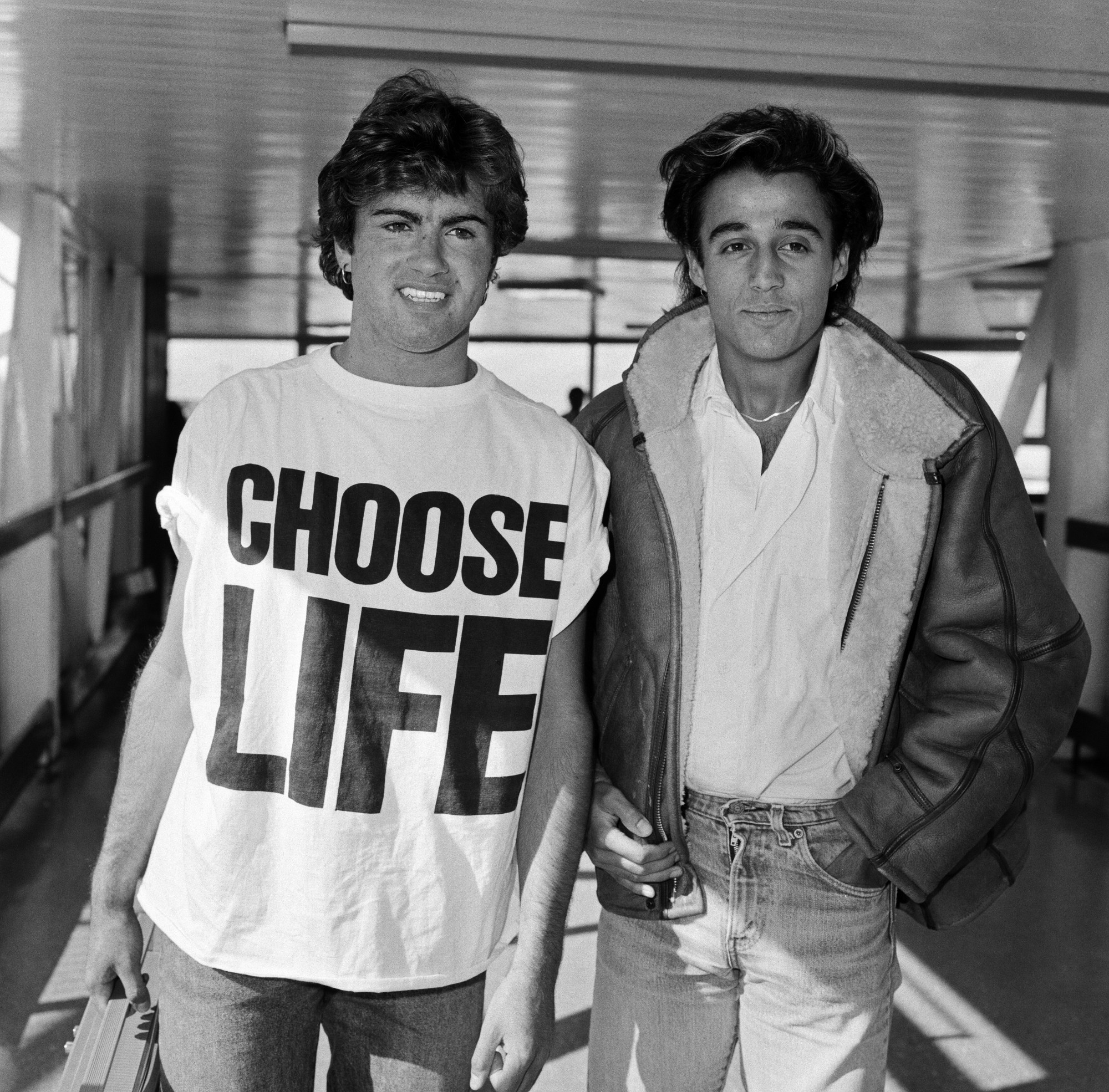 george michael wearing a CHOOSE LIFE tshirt at an airport in the 80s