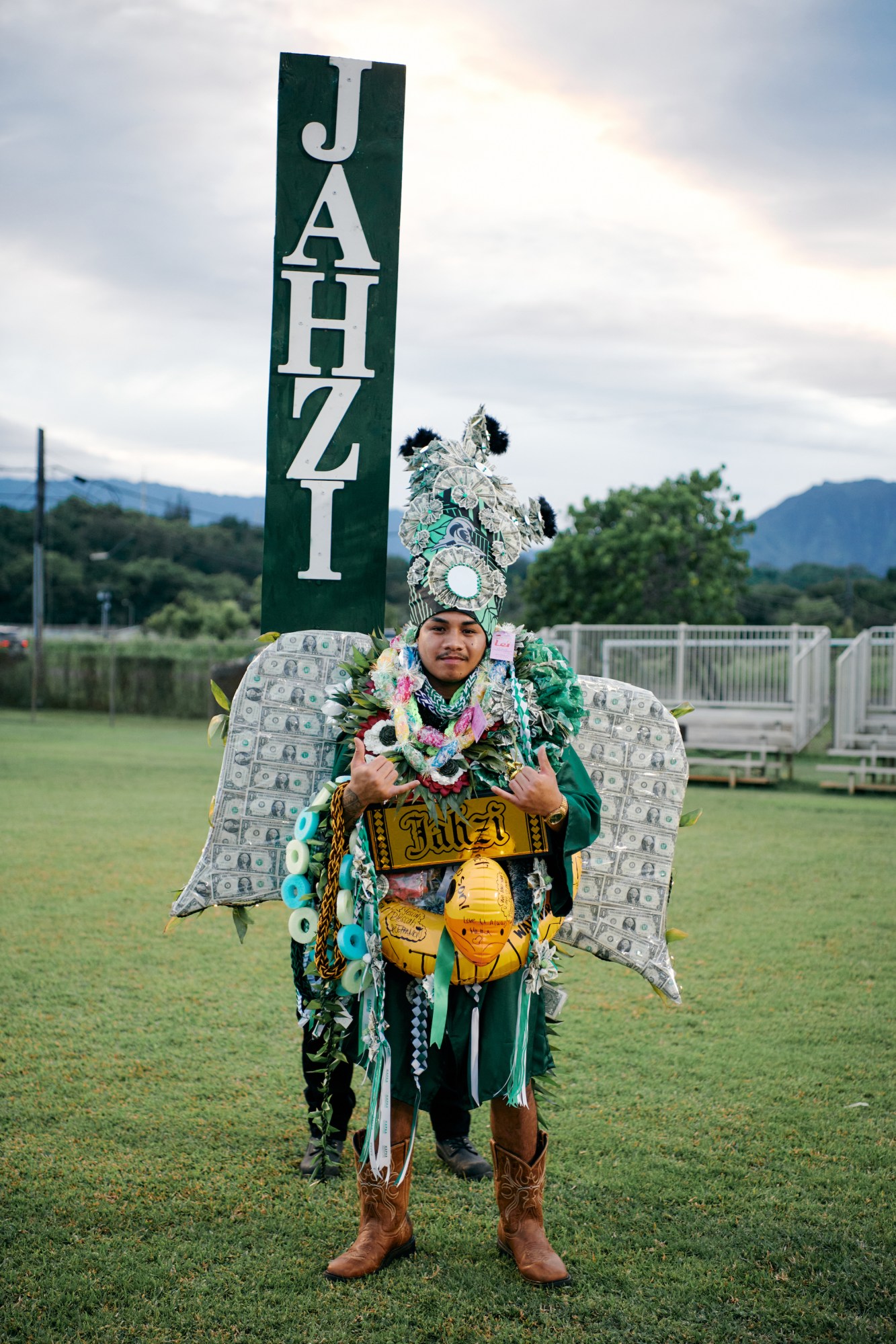 jahzi in custom leis and wings for traditional hawaiian high school graduation