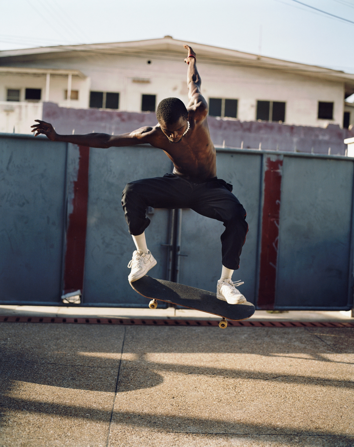 a skater in accra ghana doing a trick on his board