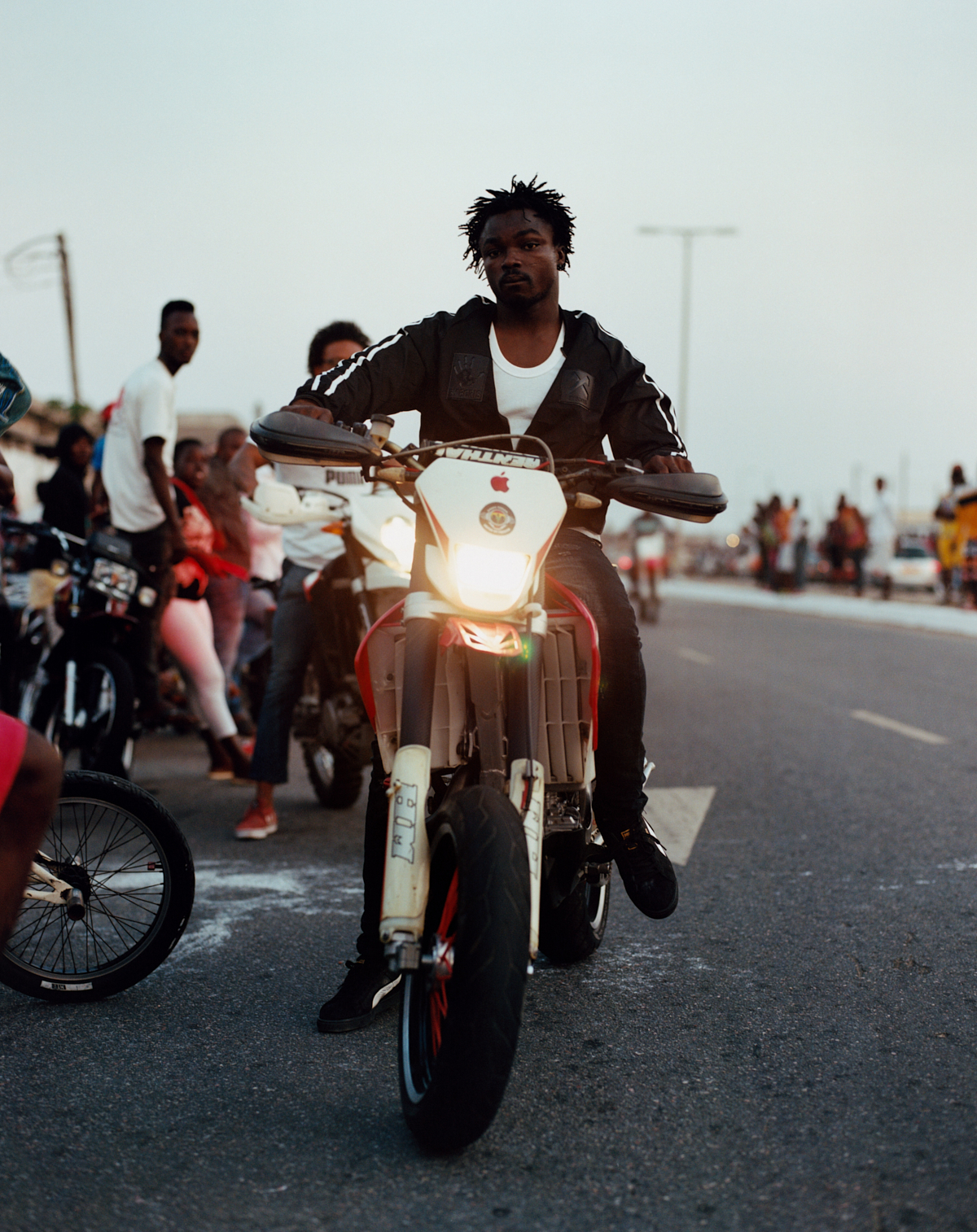 a person on a motorcycle in accra ghana photographed by kyle weeks