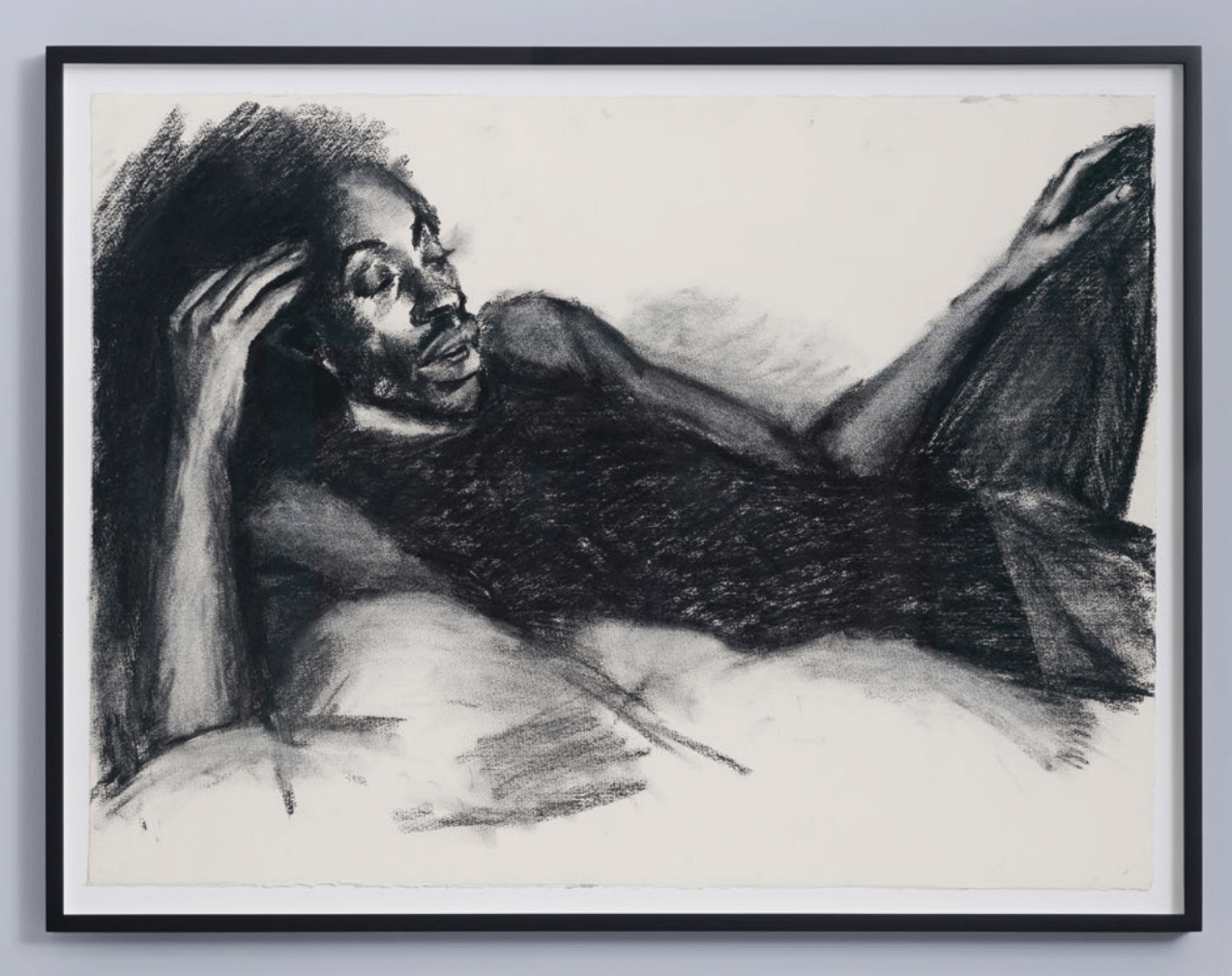 a charcoal drawing of a man reclining