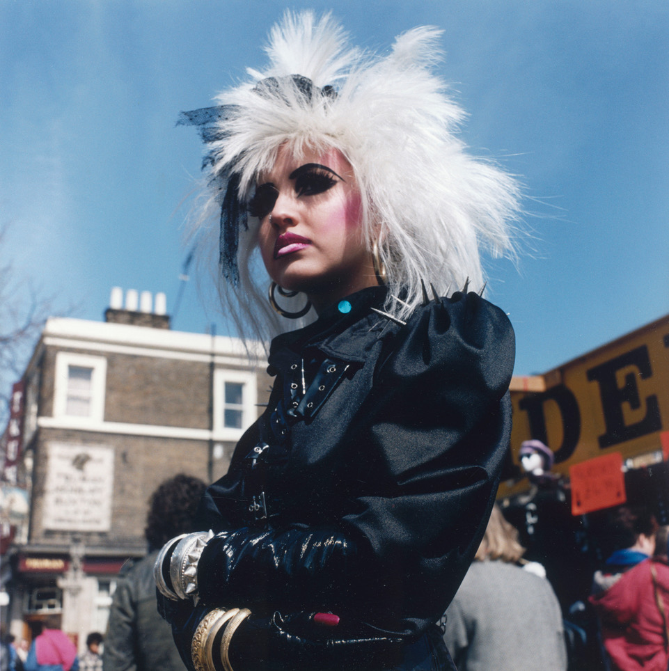 a young punk with whitte spiky hair at a market in camden