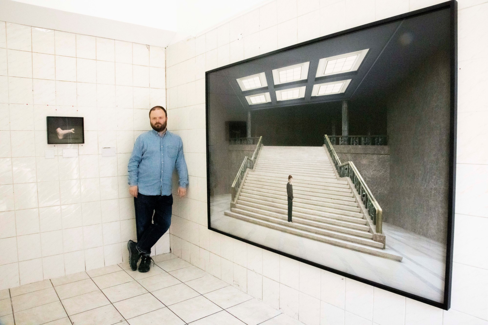 gallery owner of ginny on frederick posing with artwork in london