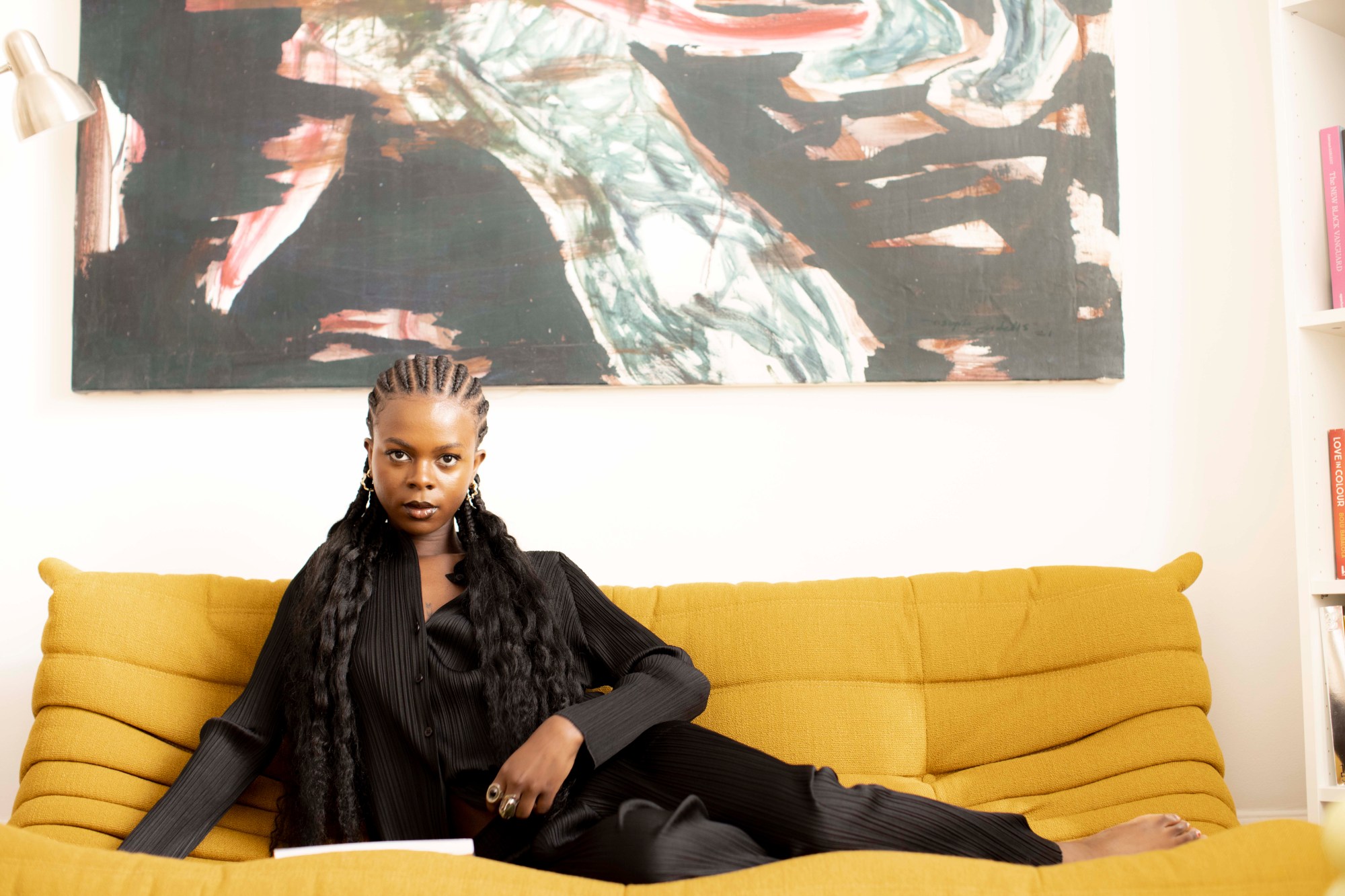 oyinkansola dada posing on a yellow couch in dada gallery