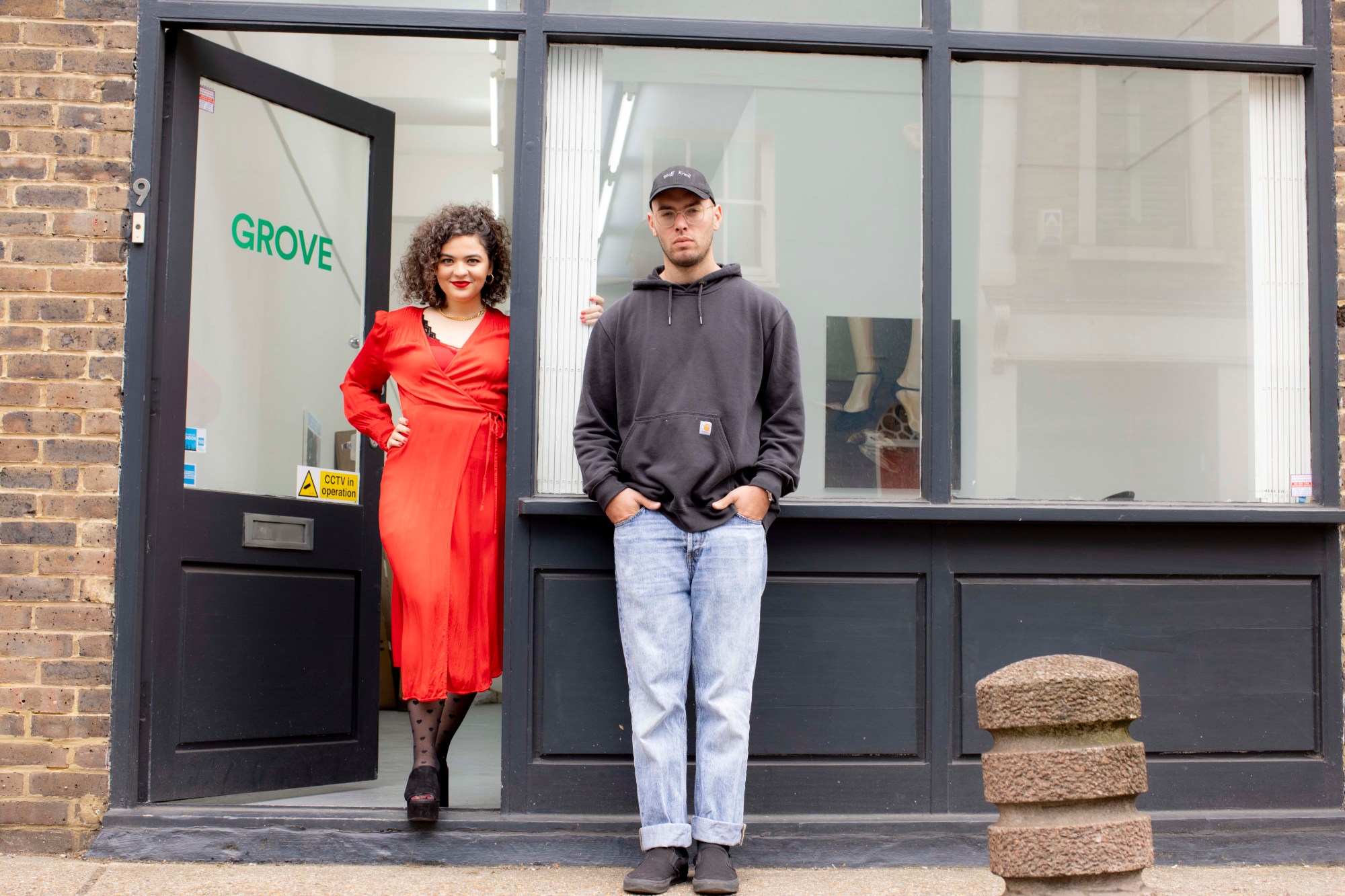 morgane wagner and jacob barnes posing in the doorway of grove gallery