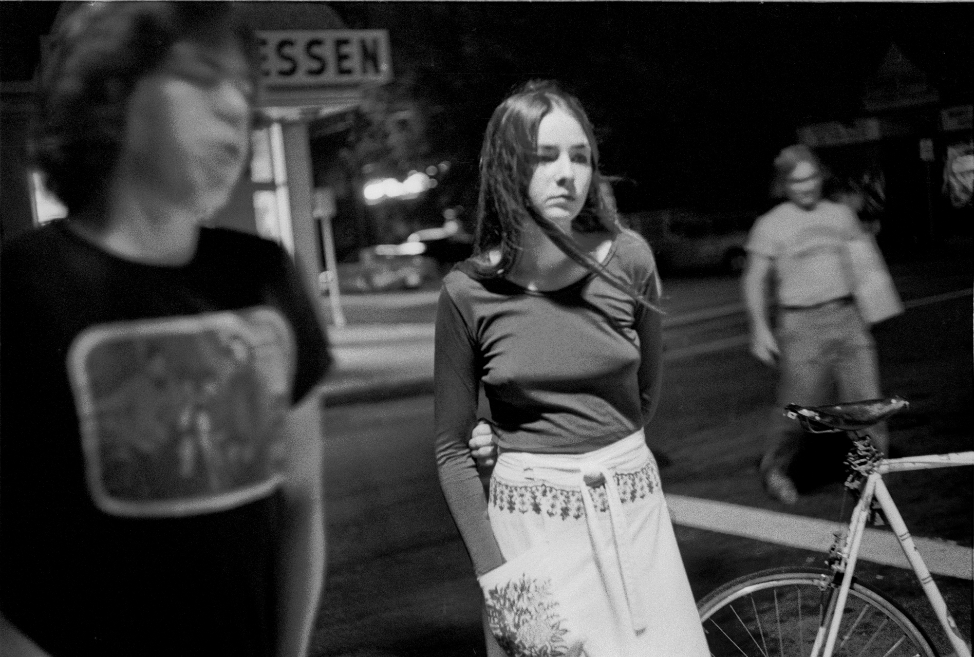 a teen girl with a bicycle on the corner by joseph szabo