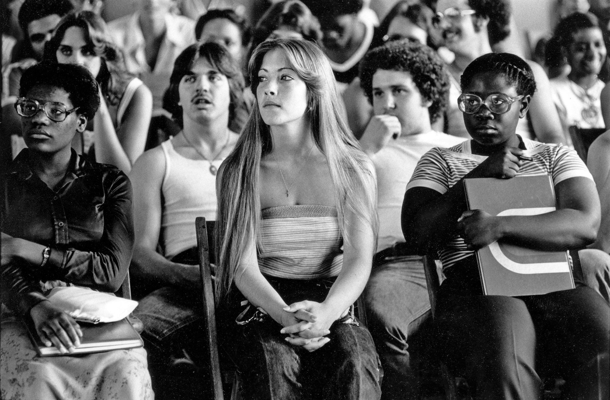 students sitting attentively at a school assembly in long island in the 1980s