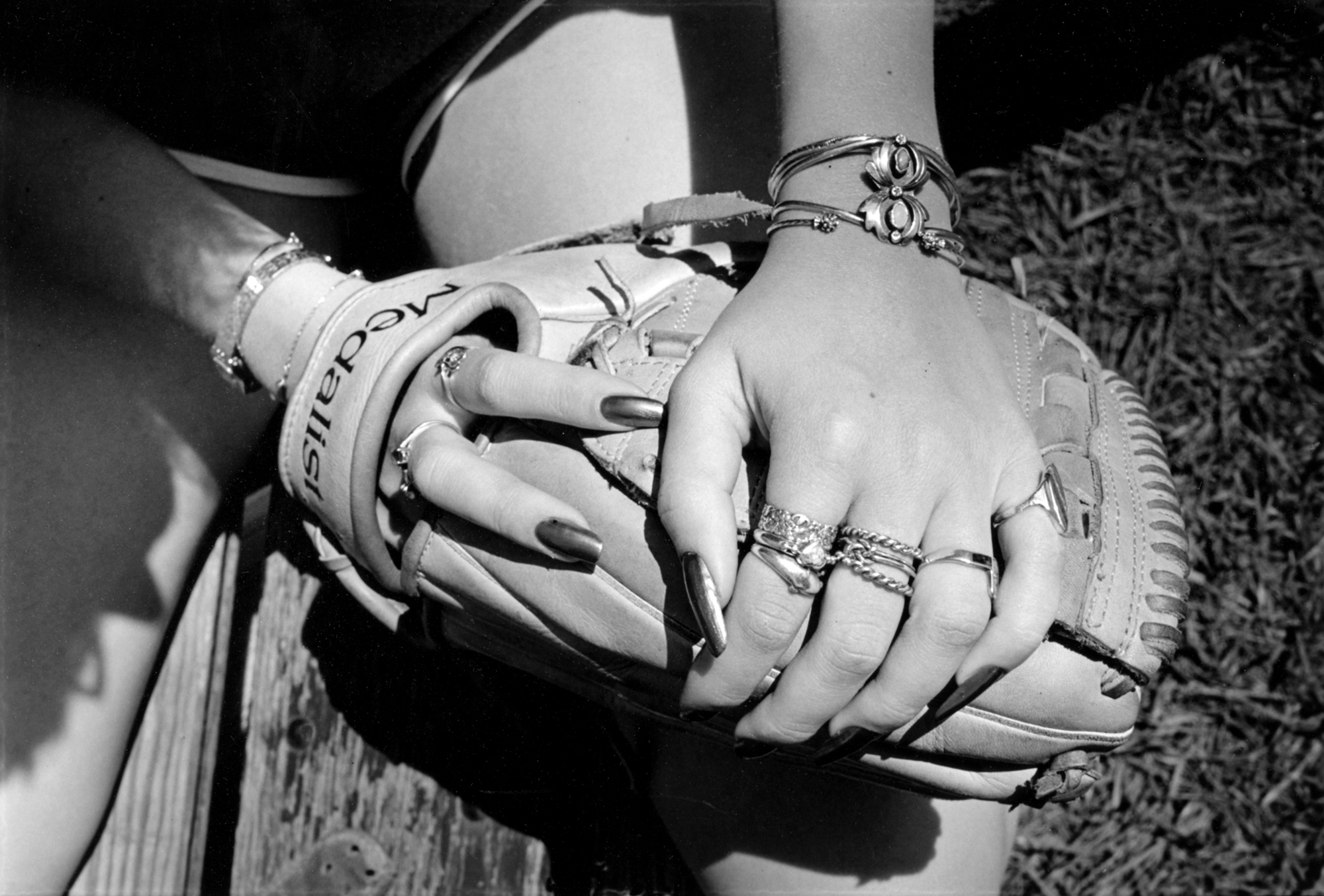 a baseball mitt and rings photographed up close by joseph szabo