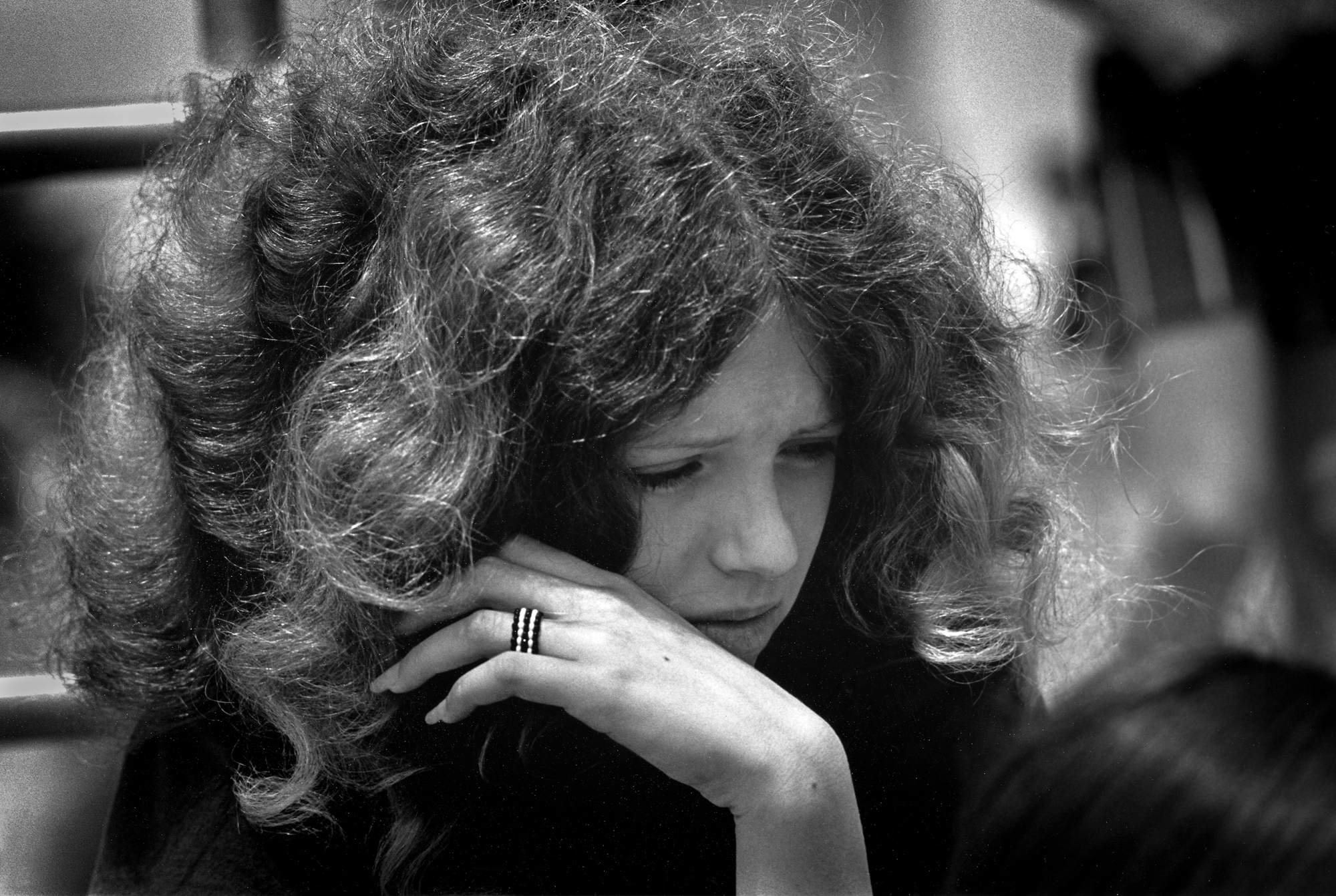 a girl with big curly hair looked distressed photographed by joseph szabo in 1969