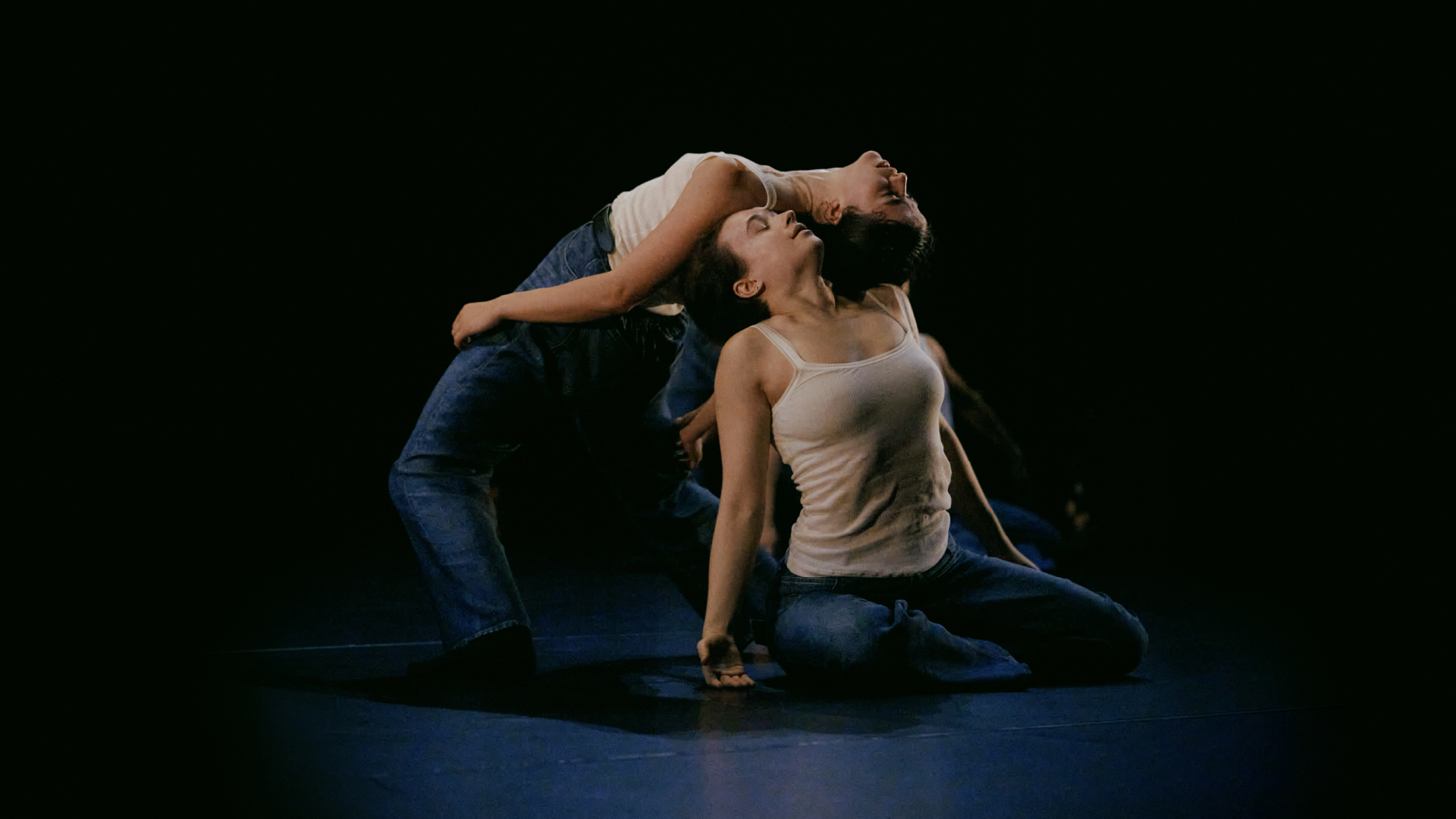 two dancers in bottega veneta white tank tops and blue denim