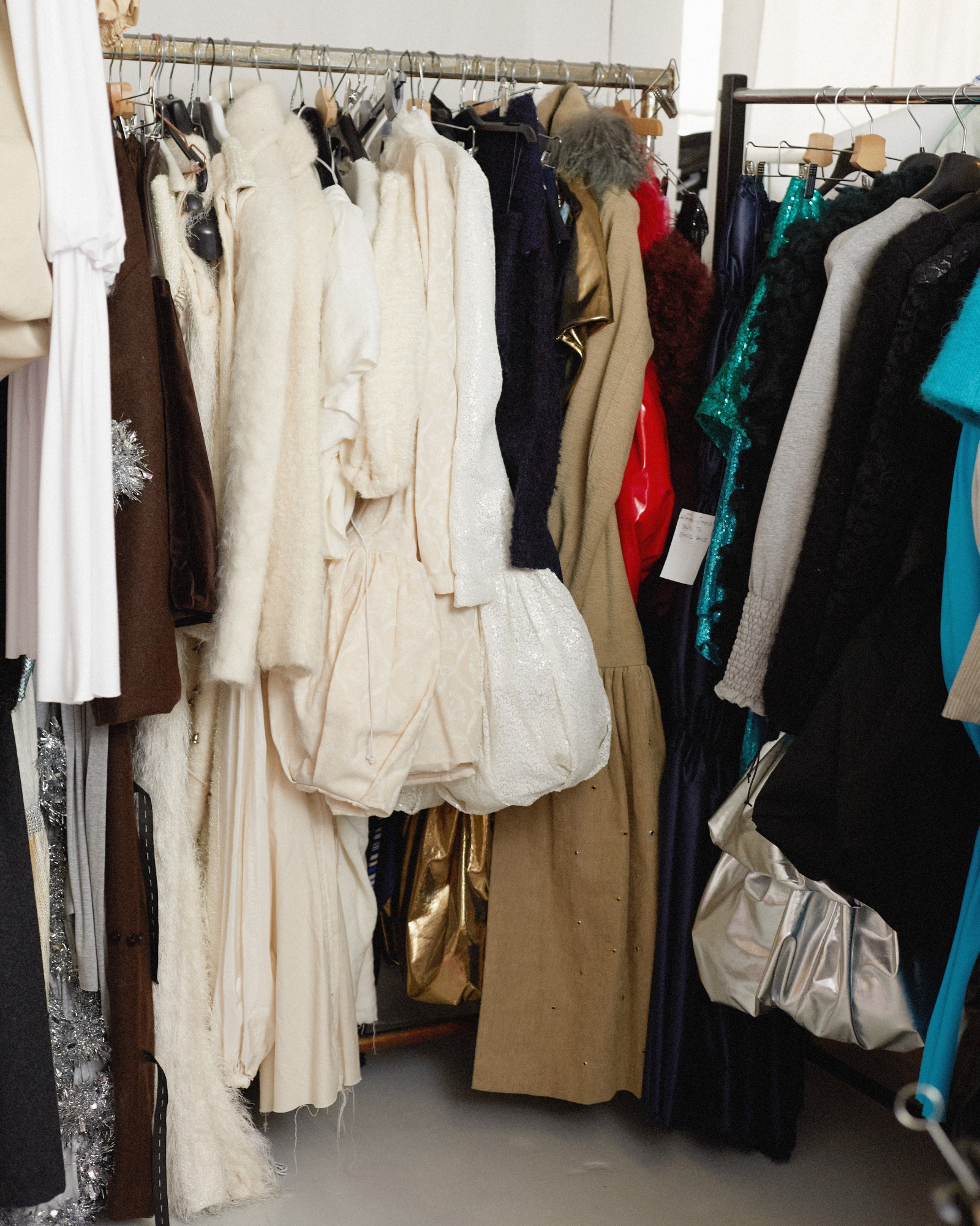 clothes hanging on the rack in nicklas skovgaard's studio