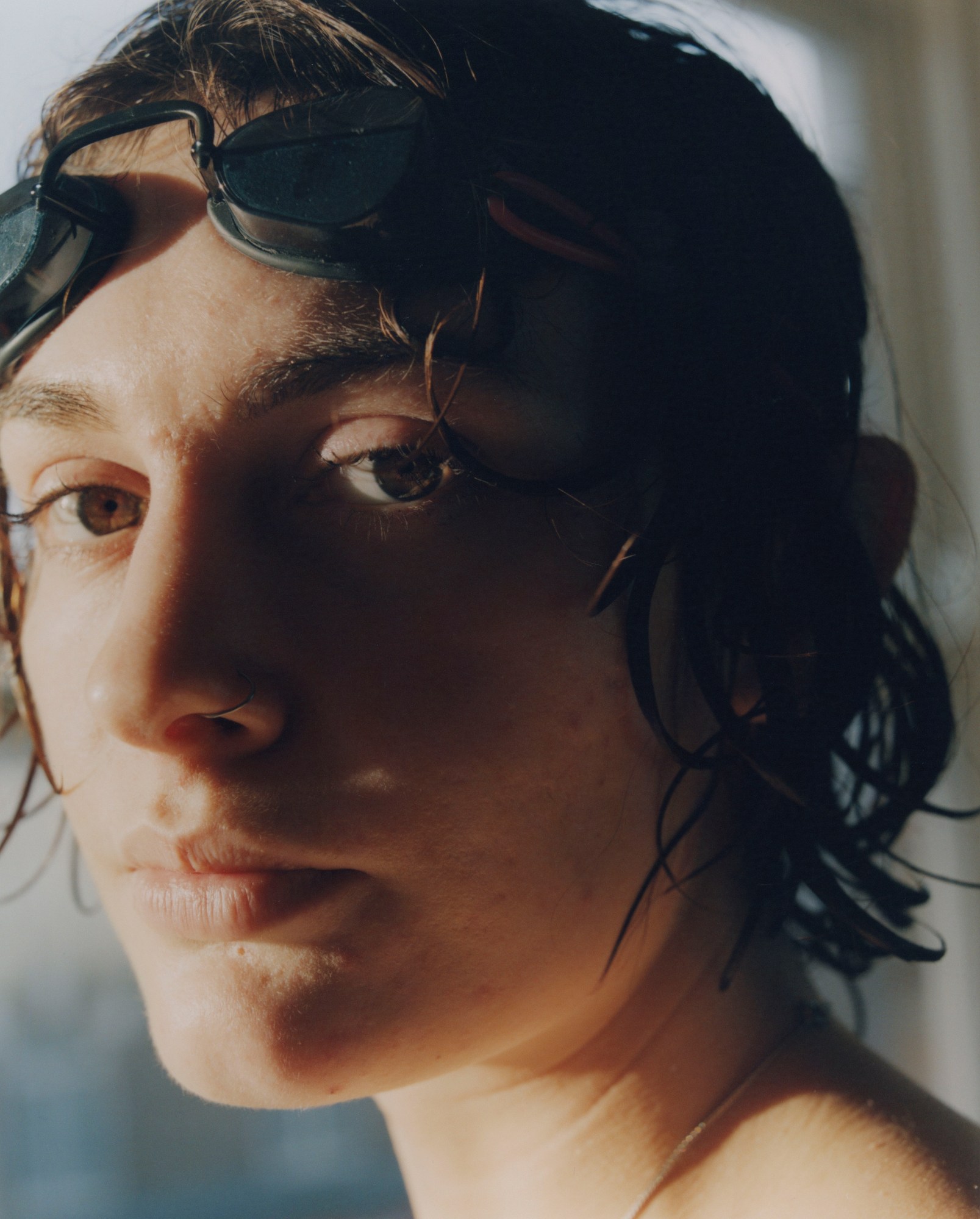 close up shot of a woman's face in profile with sunlight covering half her face