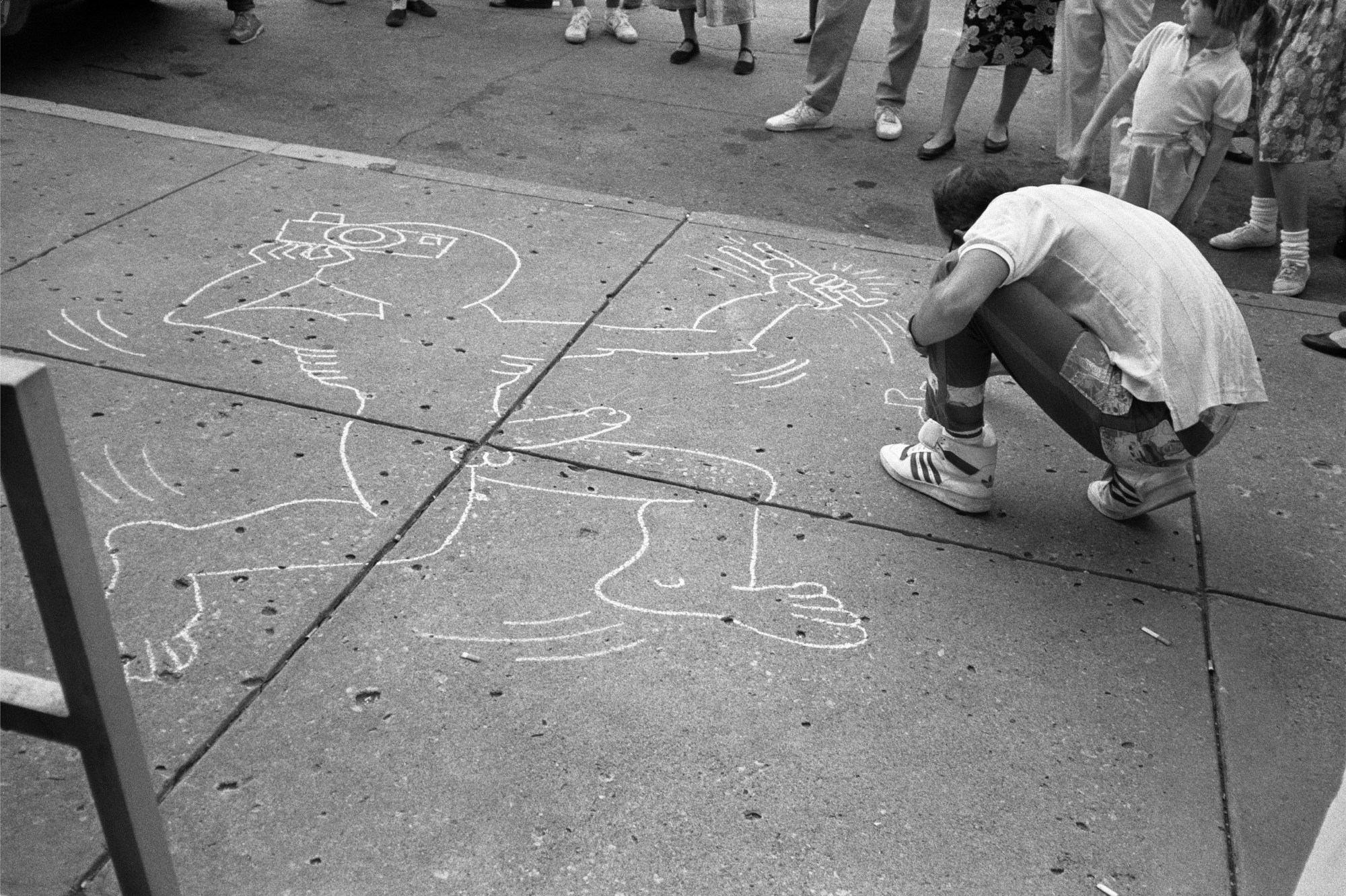 Keith Haring shot by allen Ginsberg in Lawrence, Kansas, September 11, 1987 drawing a male cartoon