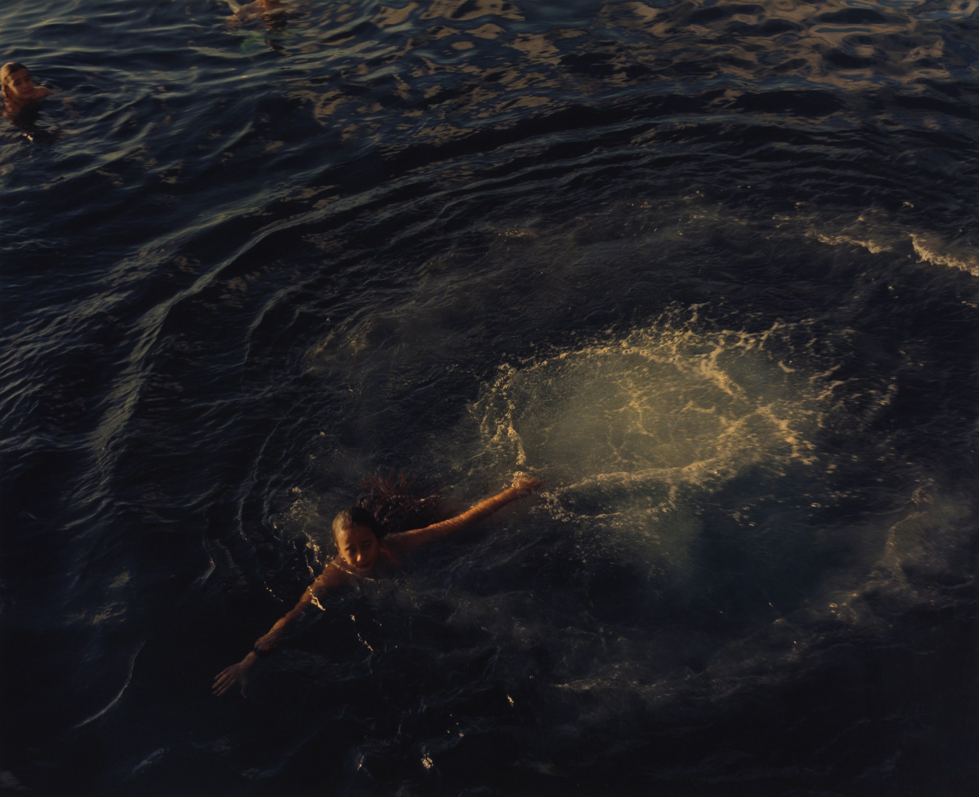 young woman swimming in the ocean