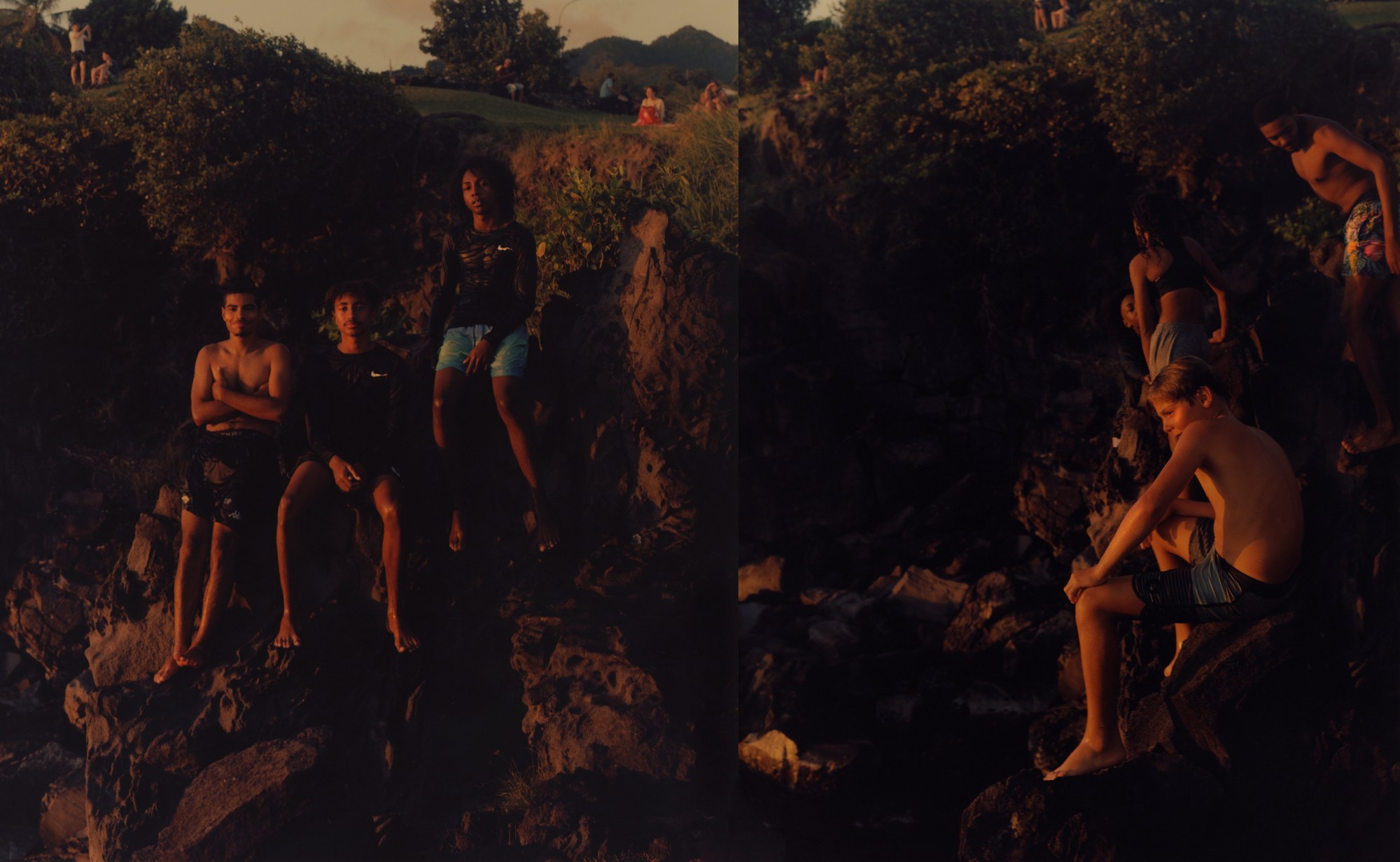 young men in swimsuits posing on rocks