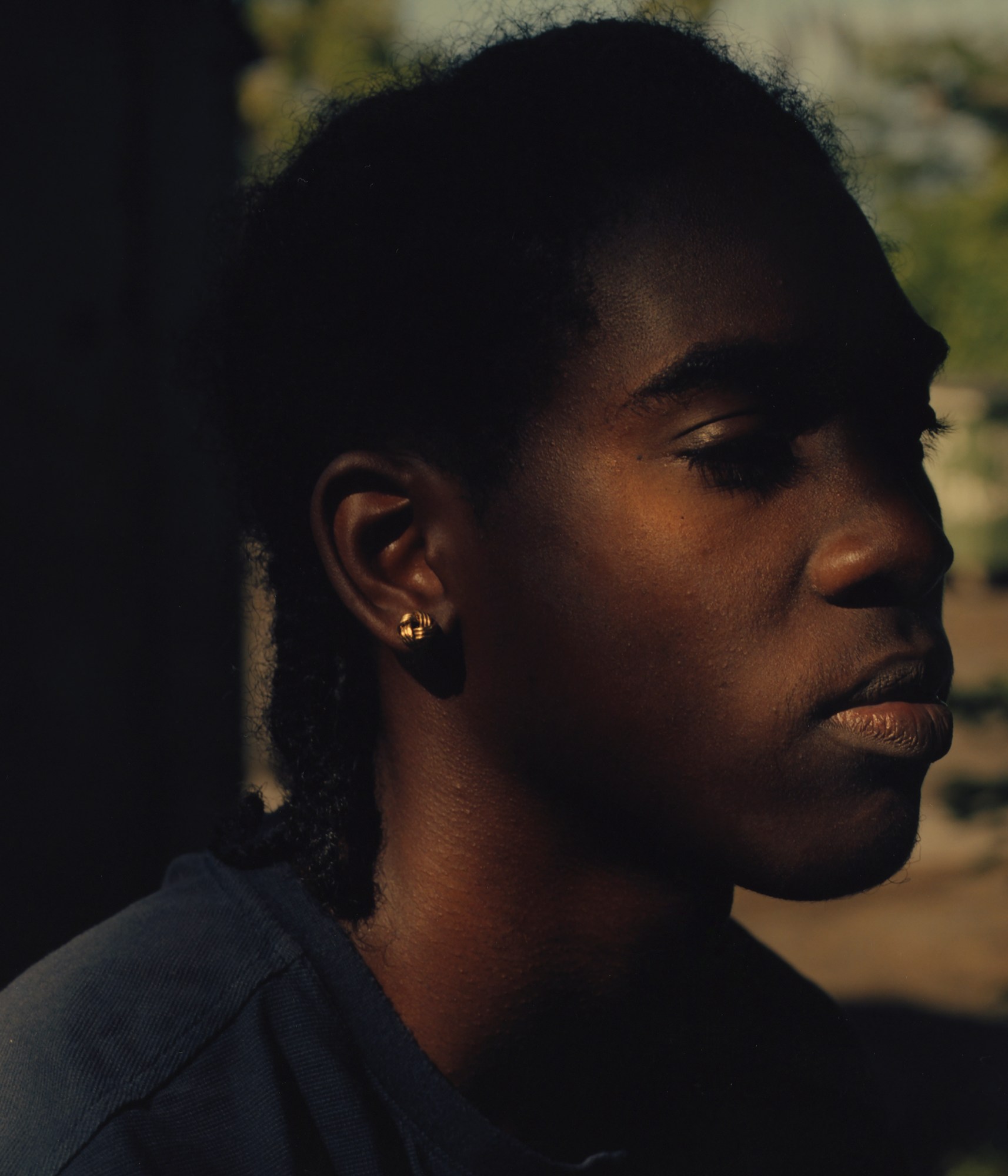 a young man with gold earring