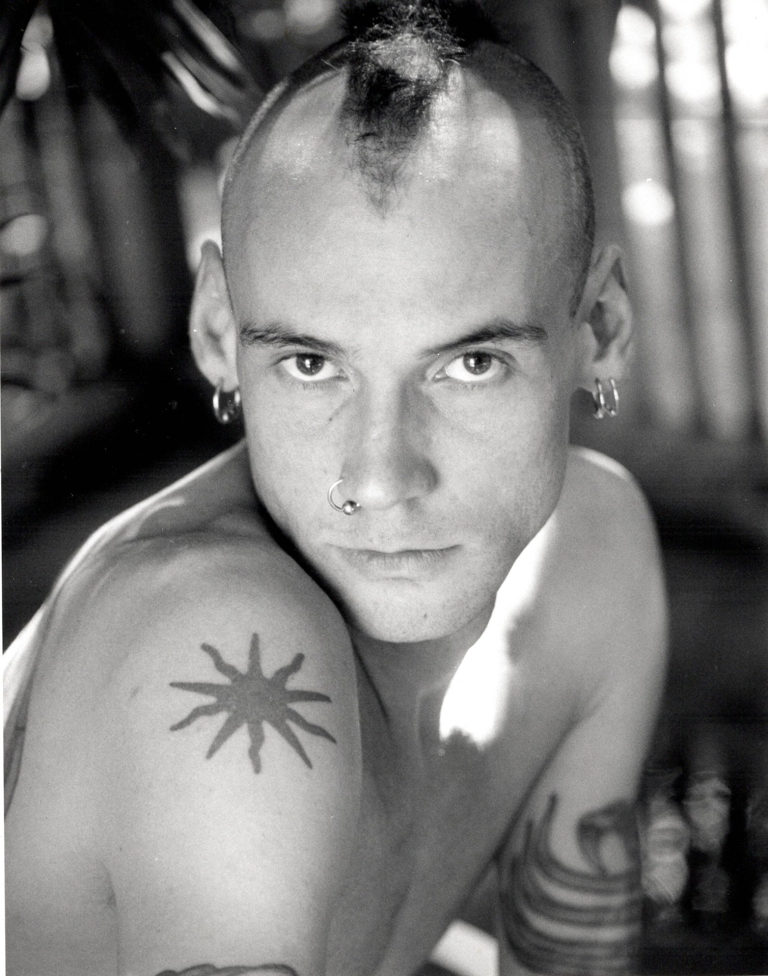 a young man with piercings and tattoos