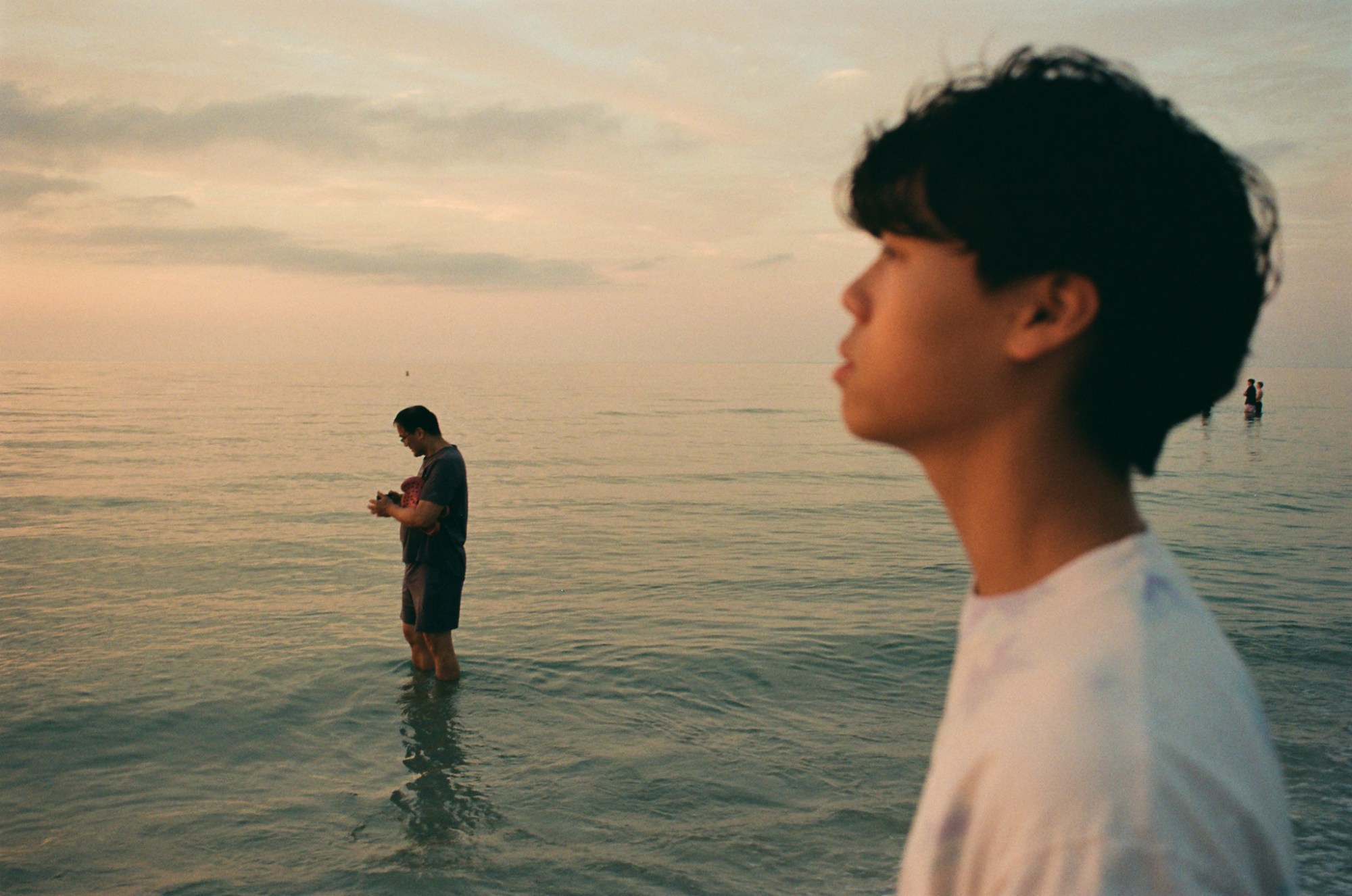 two people seen in profile in the sea at cape cod