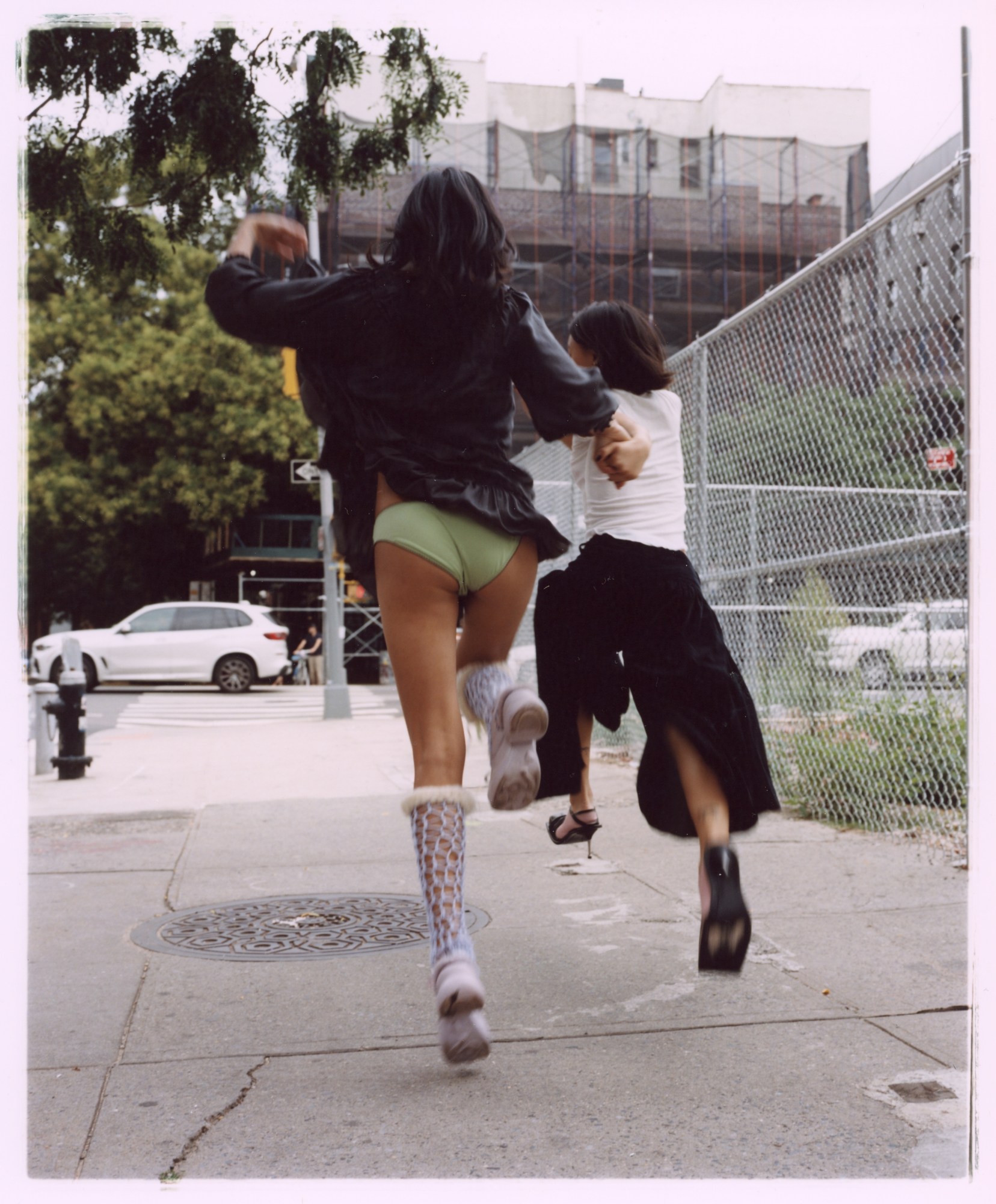 two women skipping down the street