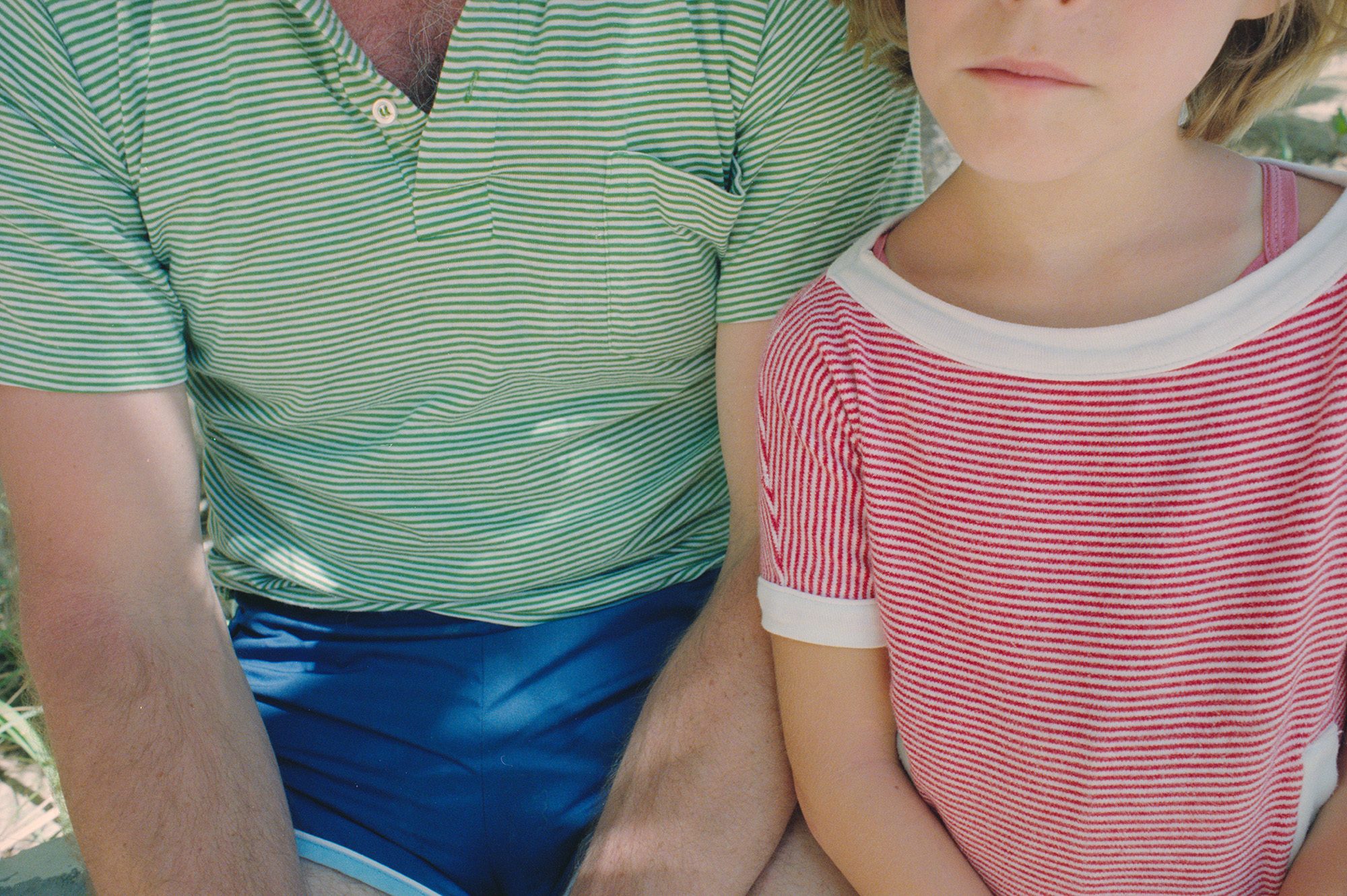 a man and young girl in green and red striped shirts