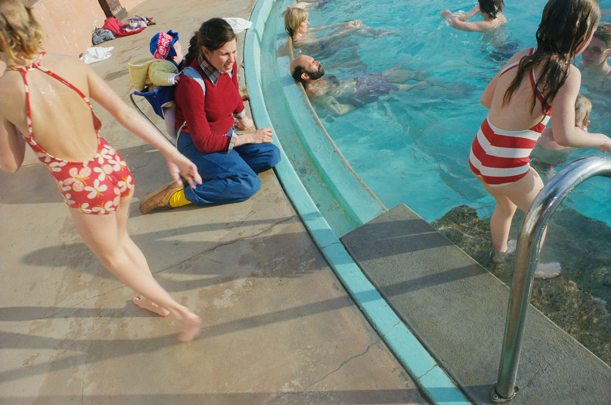 kids and adults hanging by the pool