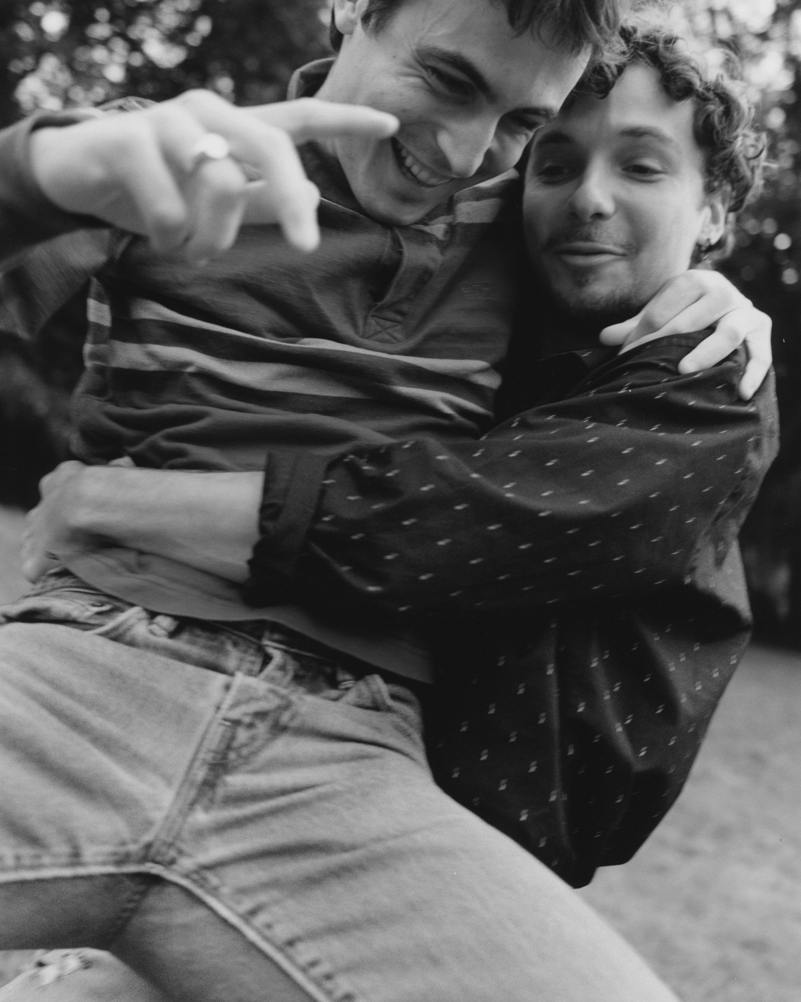 'lie with me' actors Jérémy Gillet and Julien De Saint Jean playfighting in a park