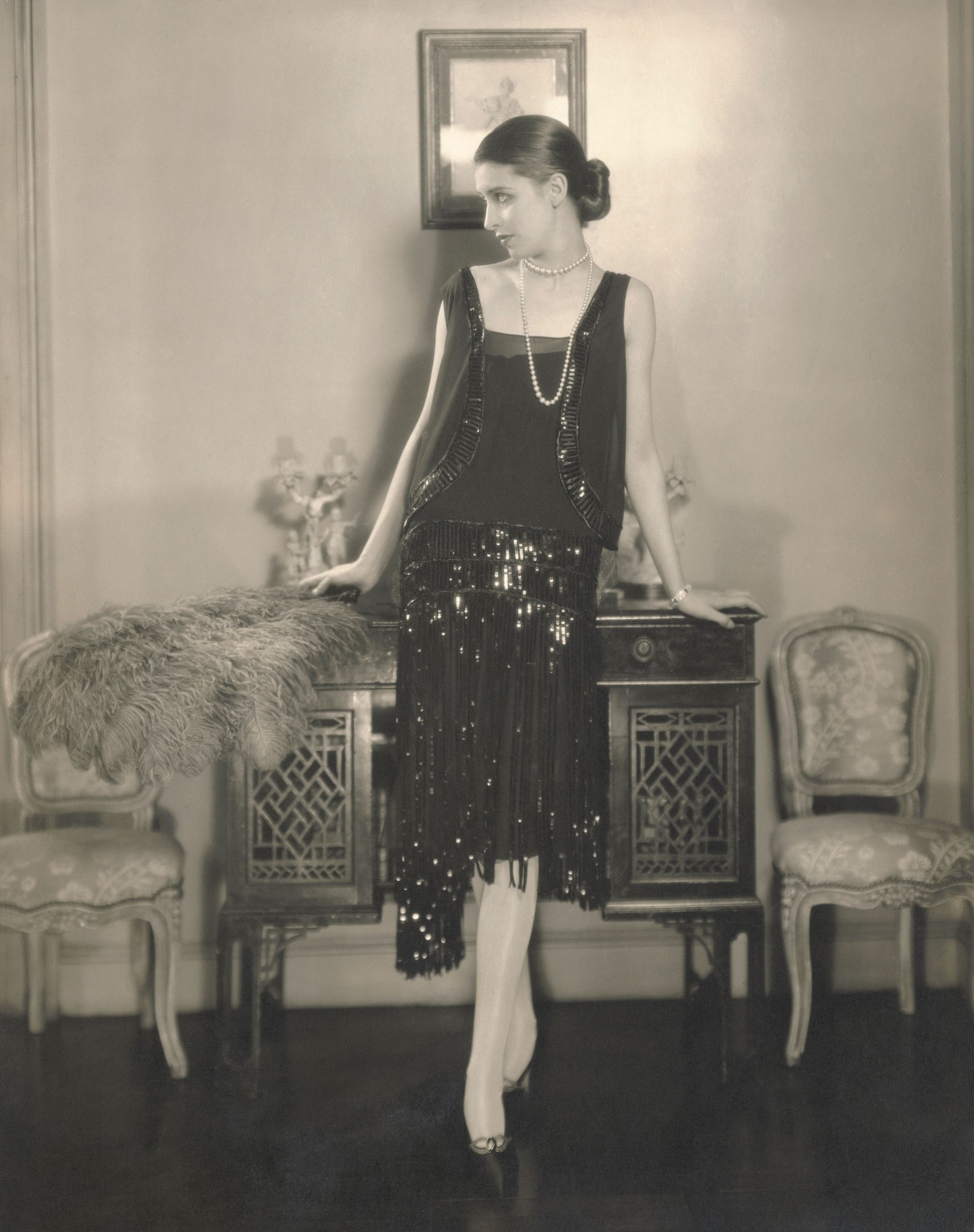 Marion Morehouse, wearing a black crepe romain bolero dress with fringed and paillette embroidered skirt by Chanel. Published in Vogue US, 1926. Edward SteichenCondé NastShutterstuck.JPG